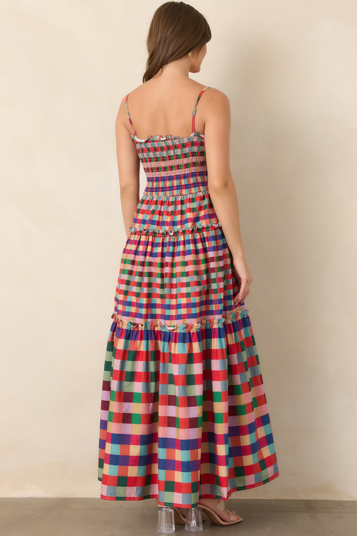 Rear of the red multi plaid maxi dress featuring a fully smocked bodice and flowing skirt.
