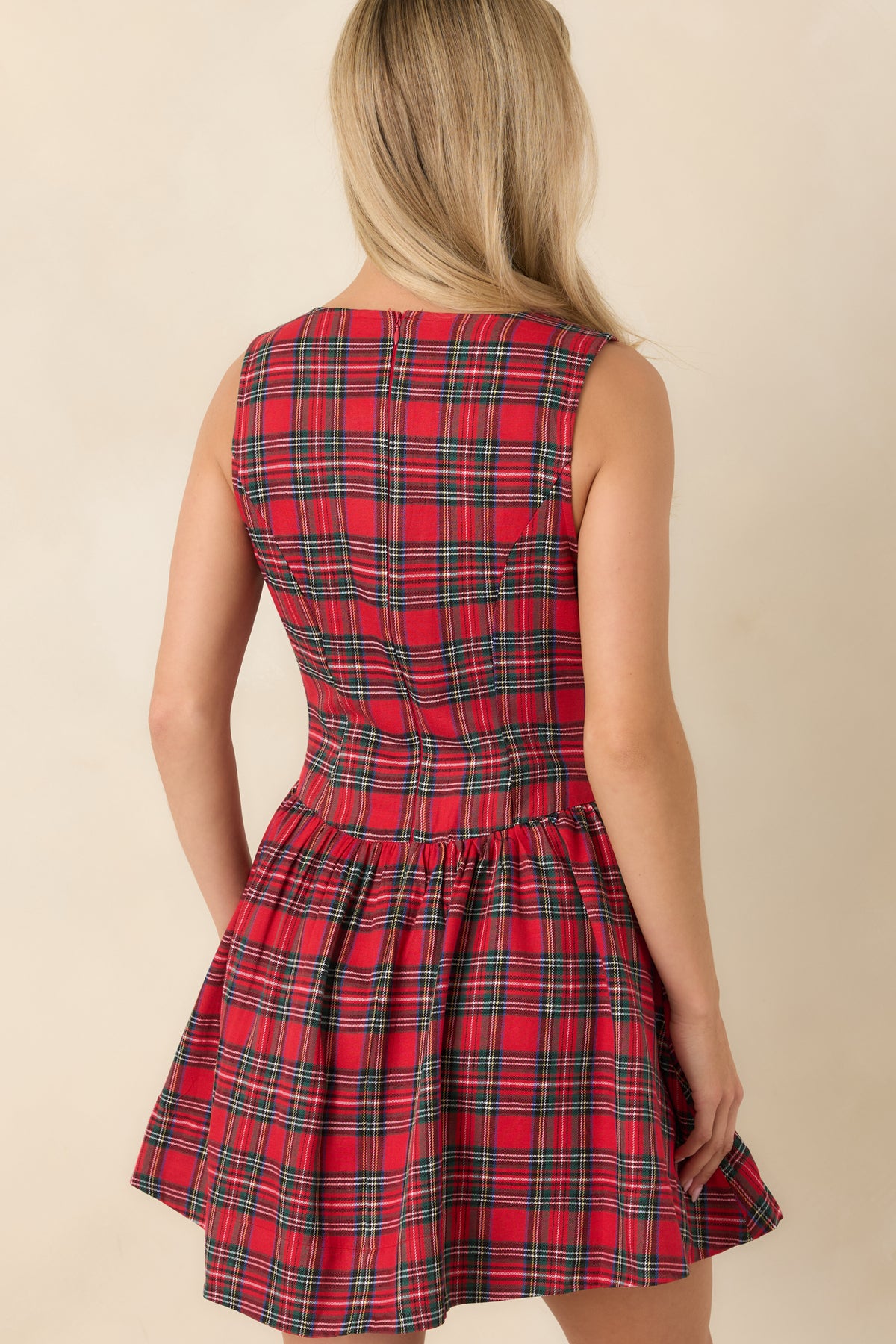 Rear view of the red tartan mini dress featuring a sleeveless fitted bodice and concealed back zipper.