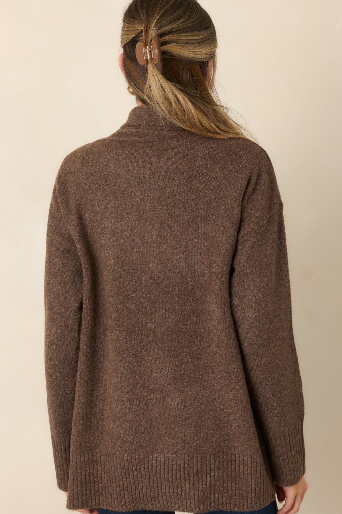 Rear of the relaxed cardigan showing its dropped shoulders, long sleeves, and ribbed hem.