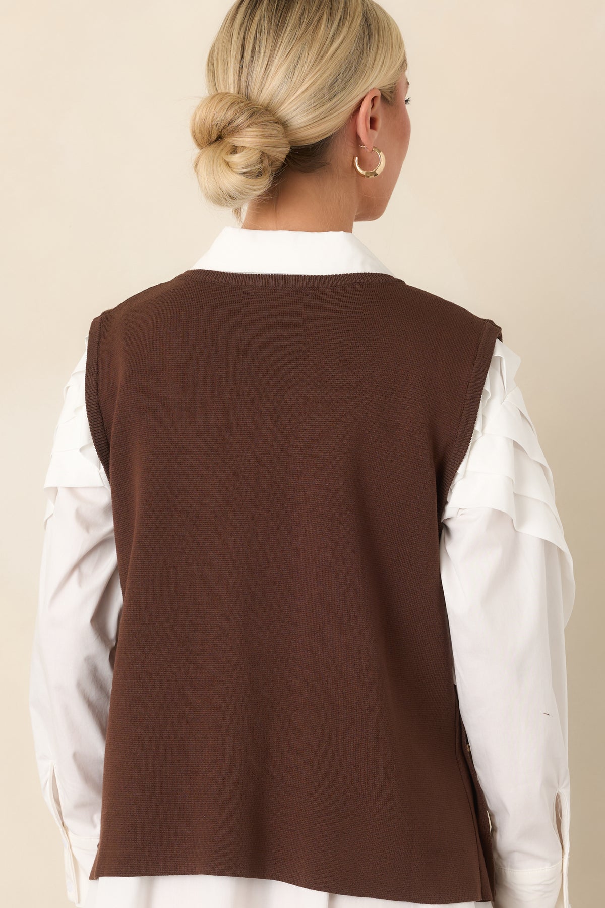 Rear of the sleeveless sweater knit top showing its relaxed draped silhouette.