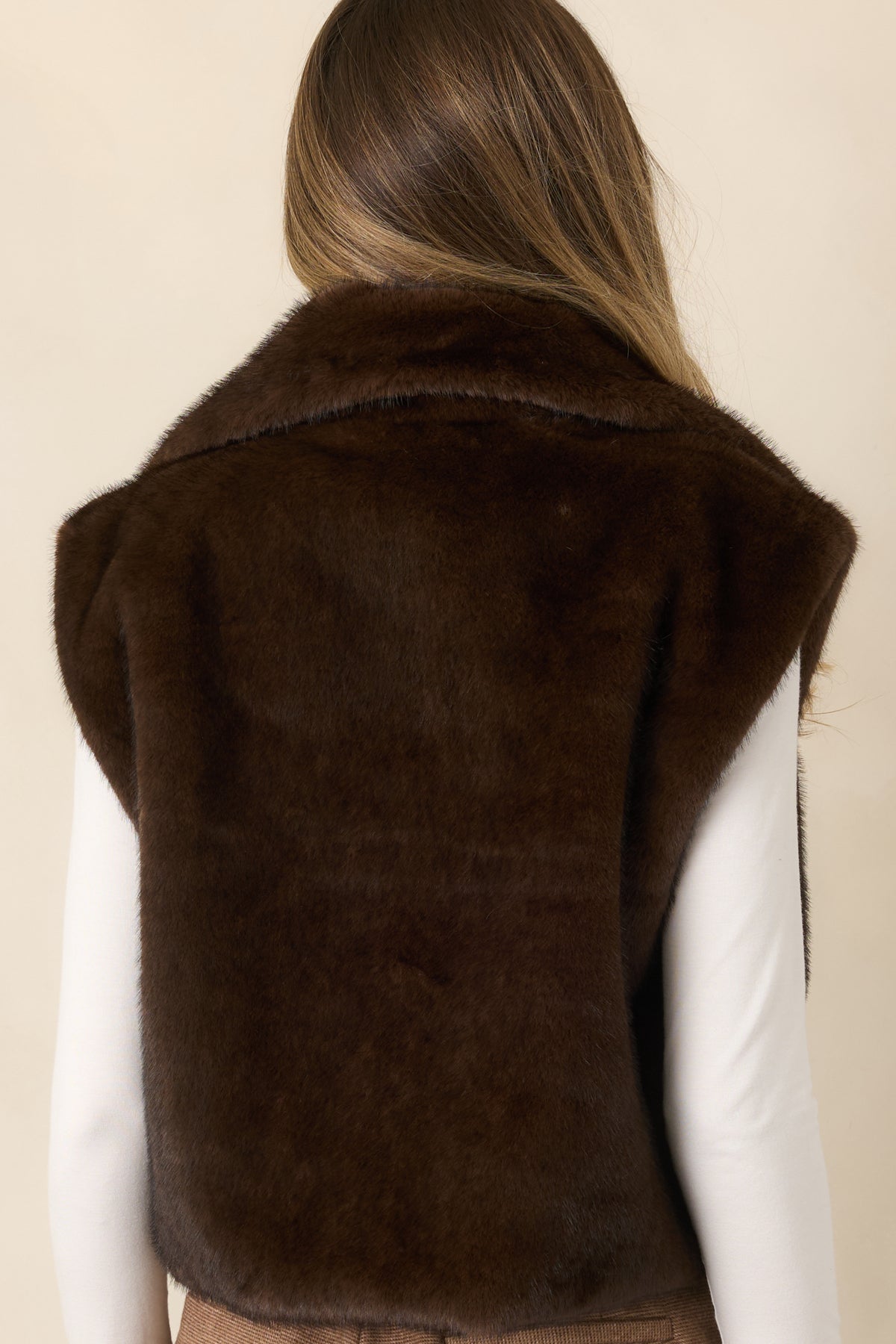 Rear view highlights the soft chocolate brown faux fur and easy, roomy shape of the vest.