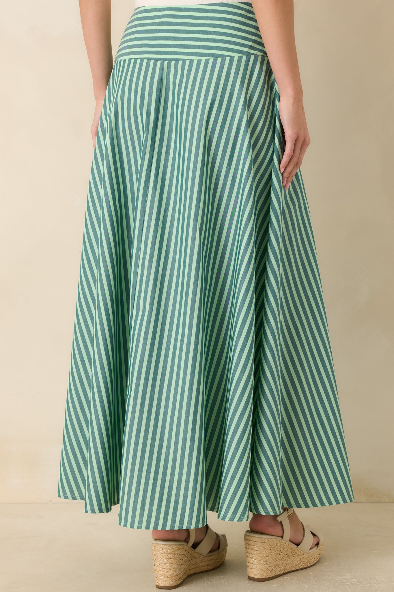 Rear view of the striped cotton maxi skirt highlighting the full sweeping silhouette, high-rise waistband, and clean drape.