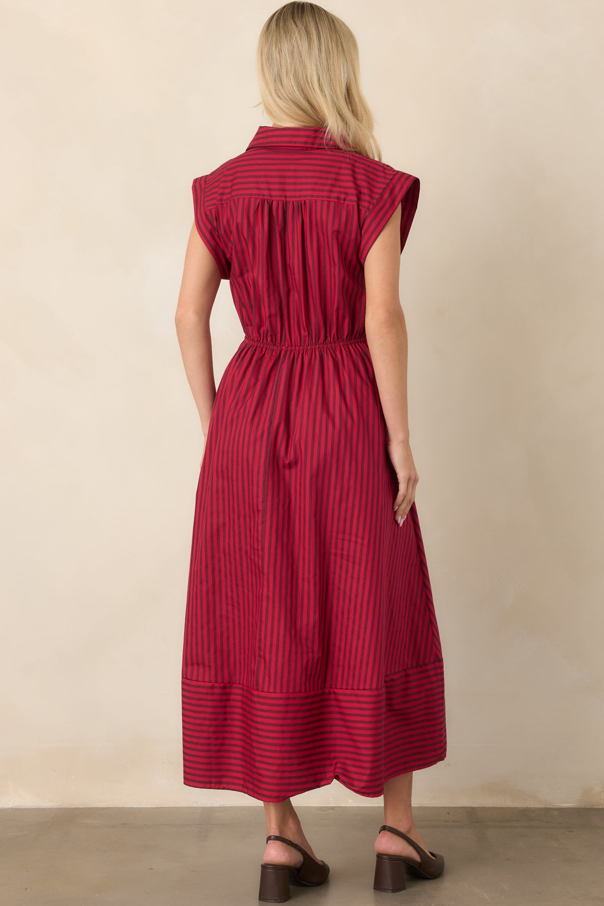 Rear view of the striped cotton midi dress showing the elastic waistband, cap sleeves, and clean flowing skirt.