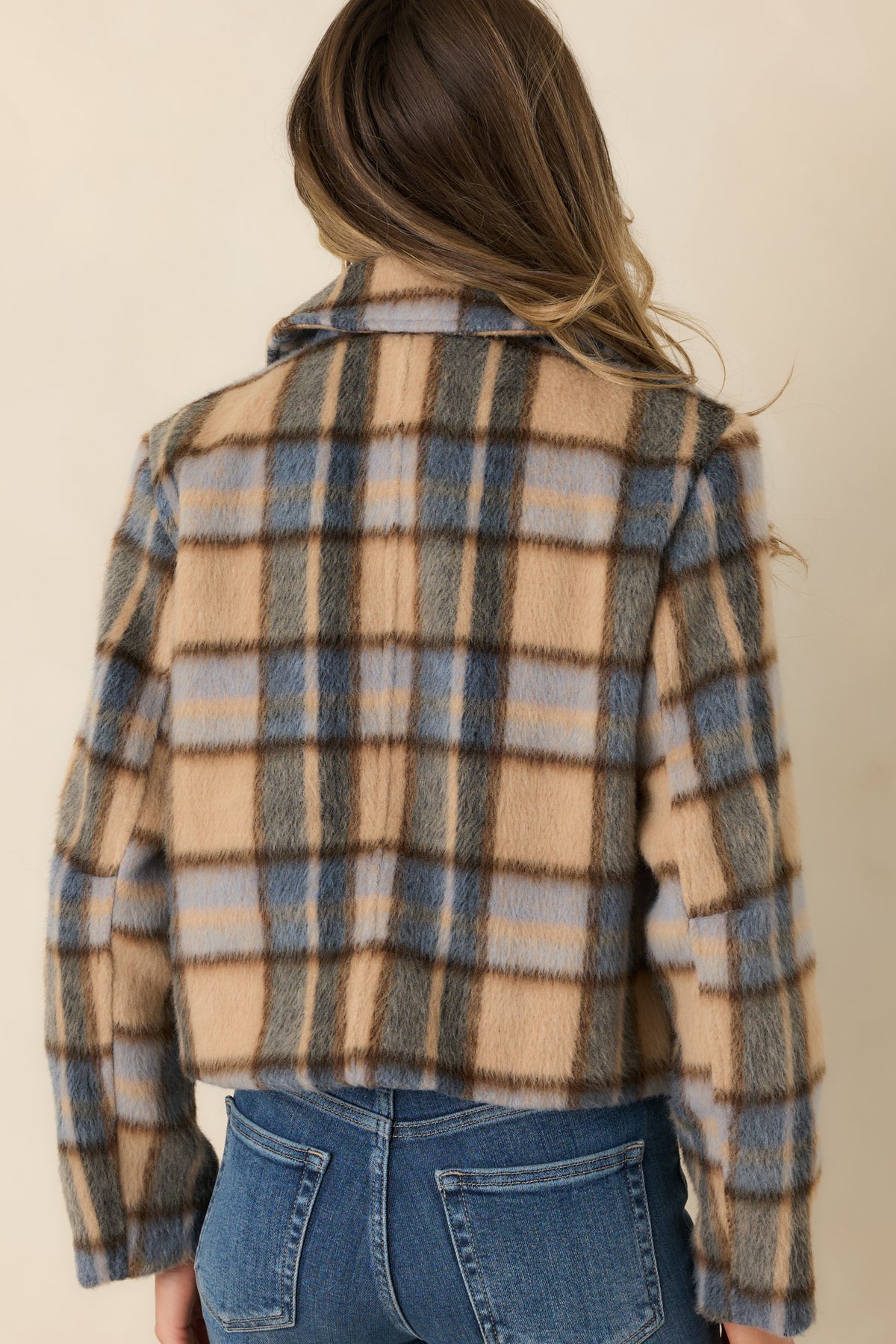 Rear view of the cropped jacket showing its brushed multicolor fabric and tailored shape.