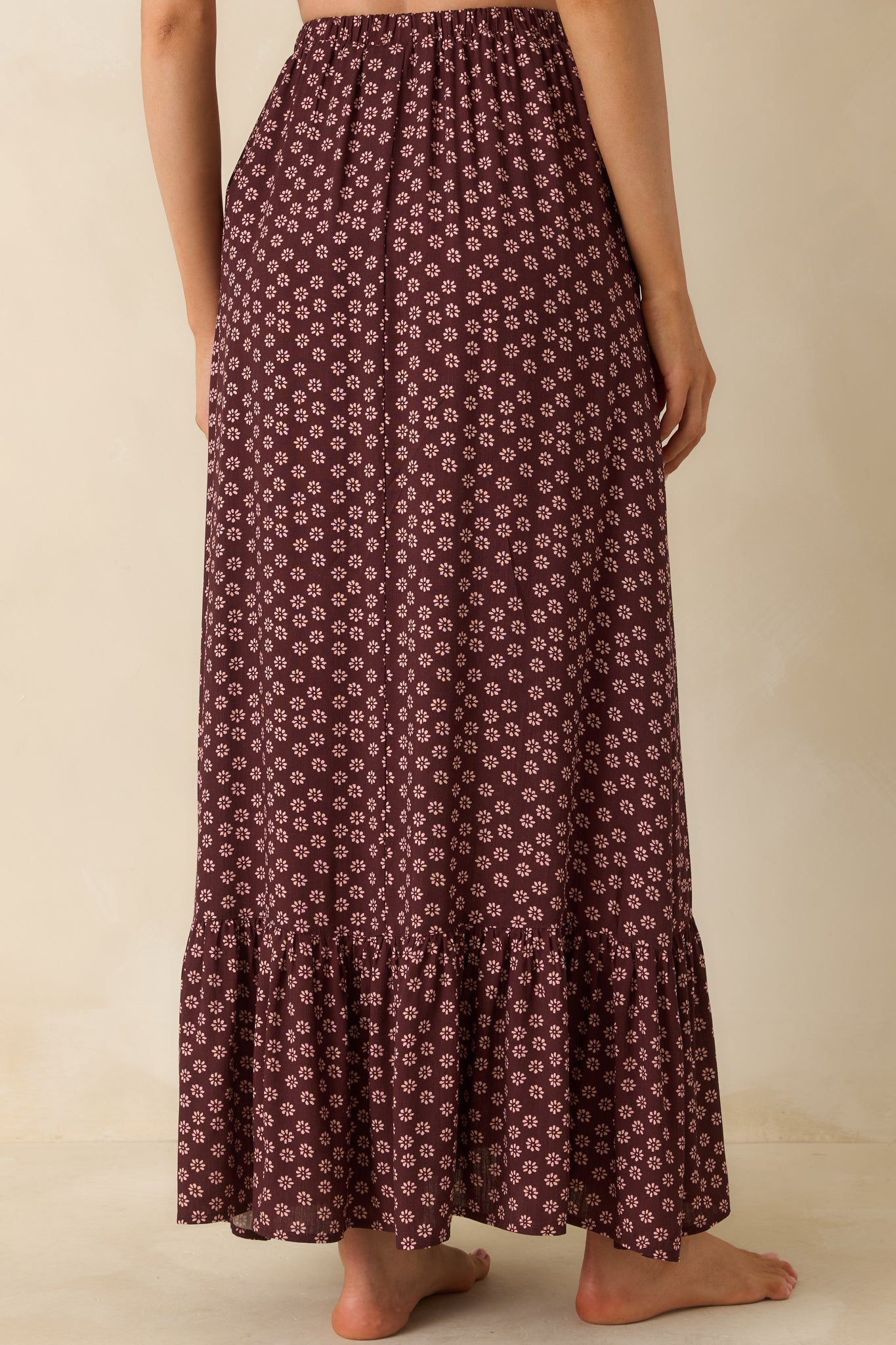 Rear view of the burgundy floral maxi skirt, showing its easy drape and flowing hem.