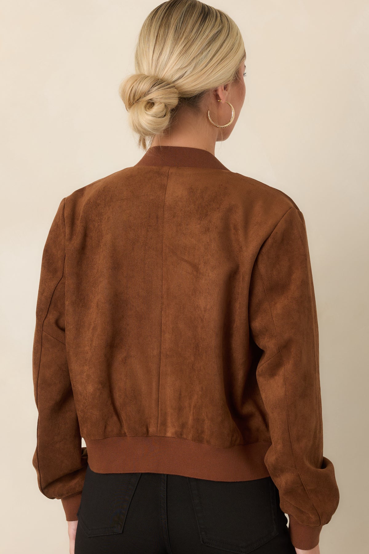 Rear view of the cognac faux suede jacket showing the relaxed silhouette and ribbed hem and cuffs.