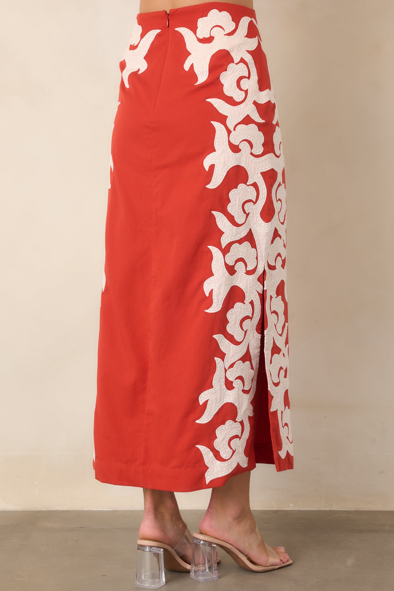 Rear view of the high-waisted cotton midi skirt featuring its column silhouette, concealed zipper, and clean finish.