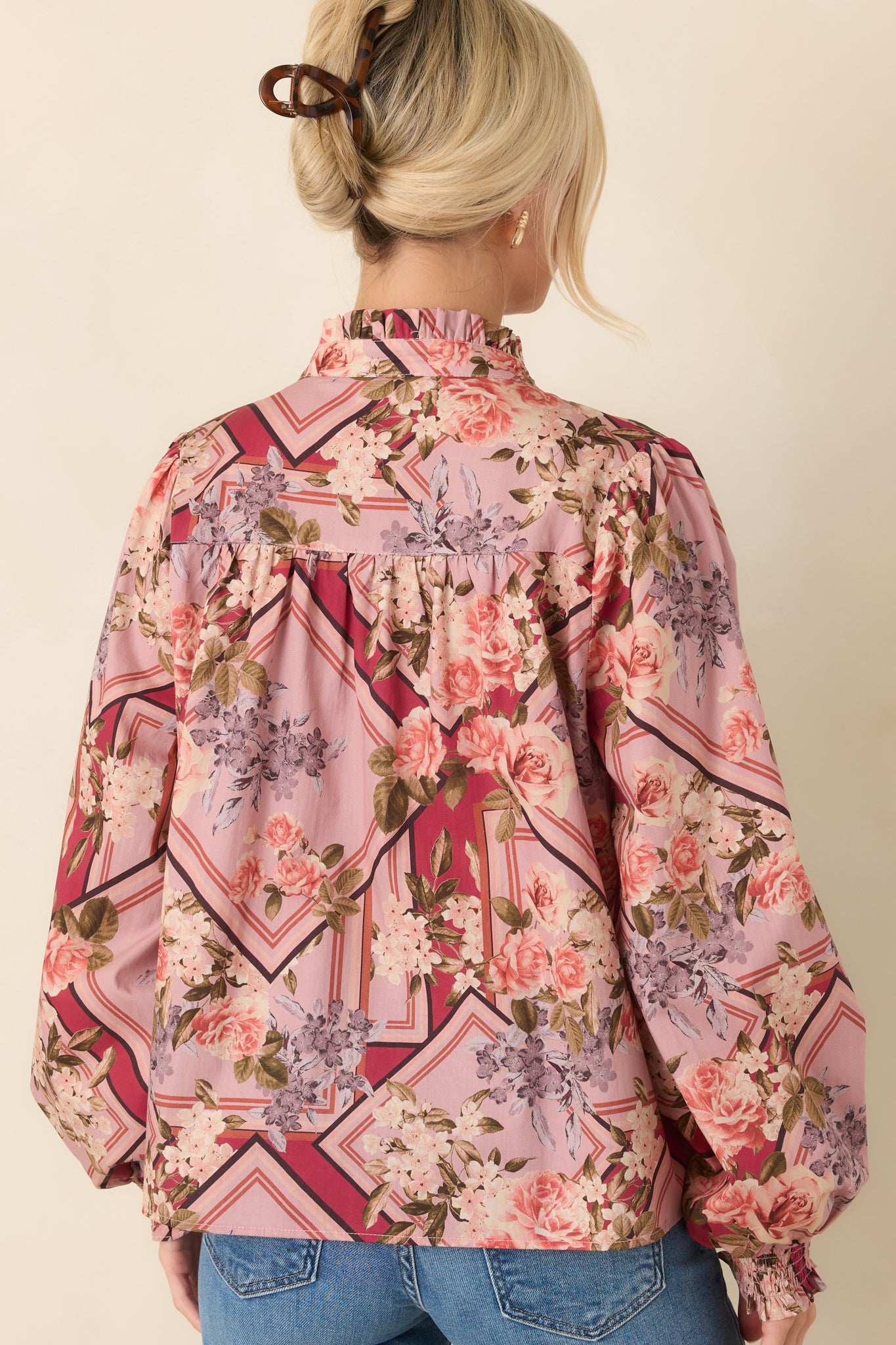 Rear view of the cotton top showcasing the gathered yoke, voluminous long sleeves, and smocked cuffs.