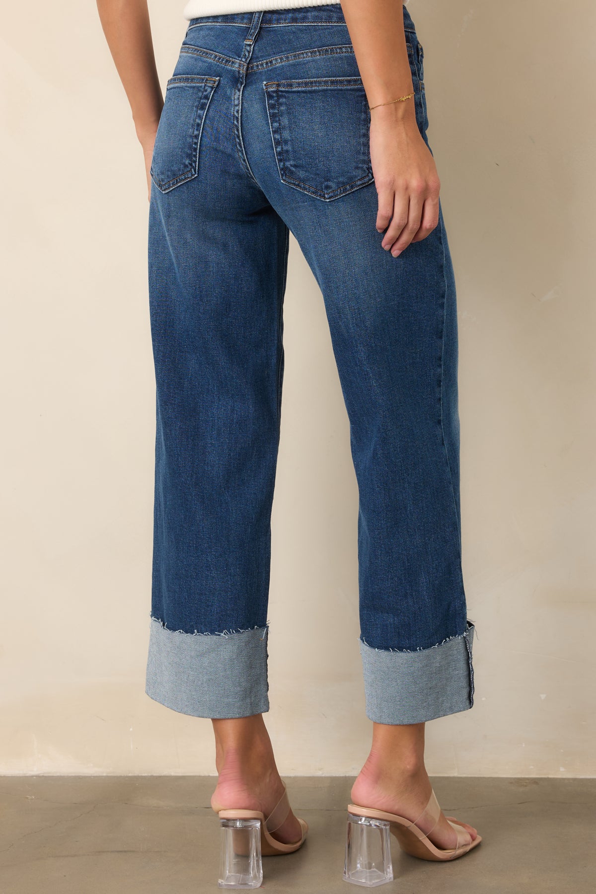 Rear view of dark wash wide-leg jeans with classic five-pocket styling.