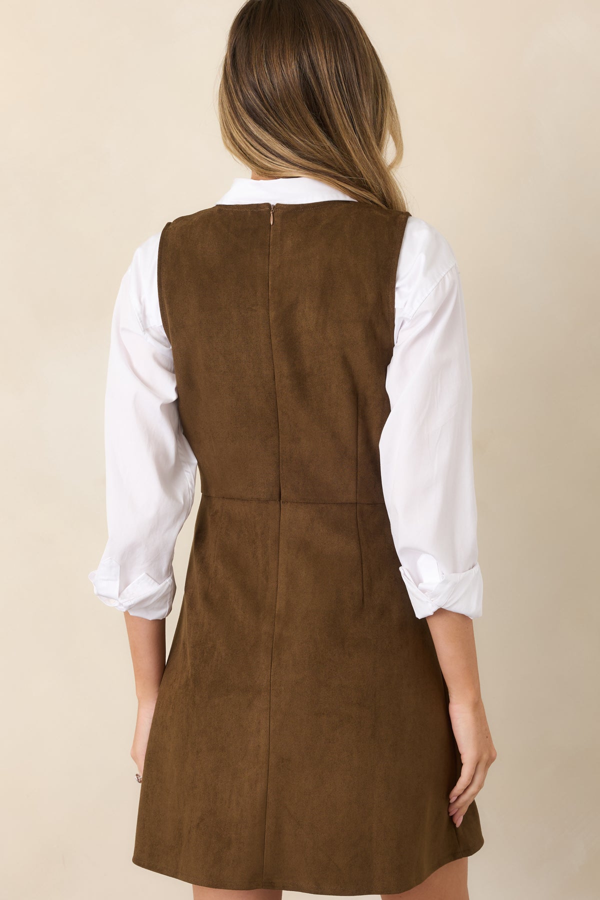 Rear view of the faux suede mini dress showcasing its structured sleeveless bodice, defined waist, flared A-line skirt, and concealed zipper closure.