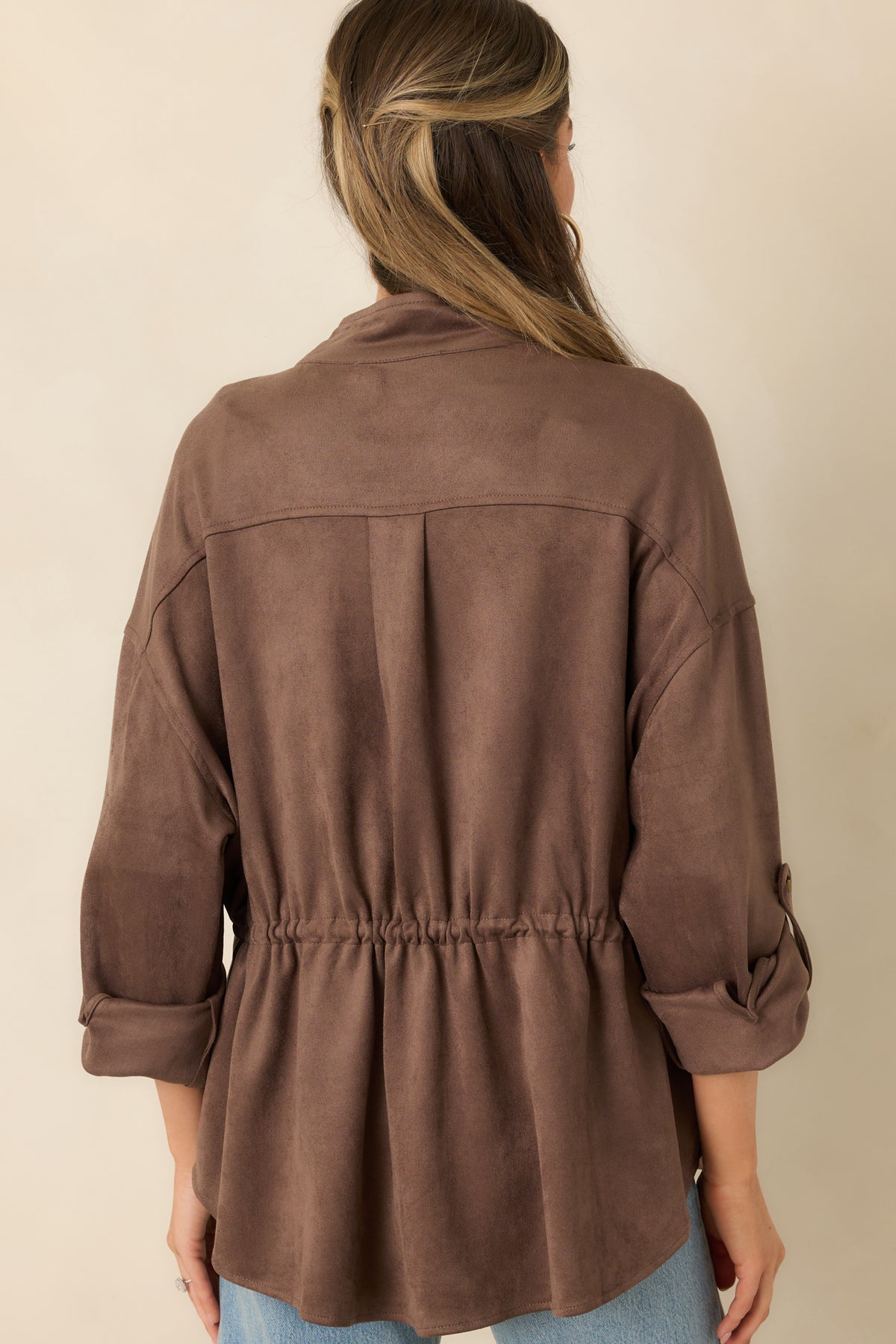 Rear view of the faux suede jacket showing its relaxed shape, dropped shoulders, and curved hem.