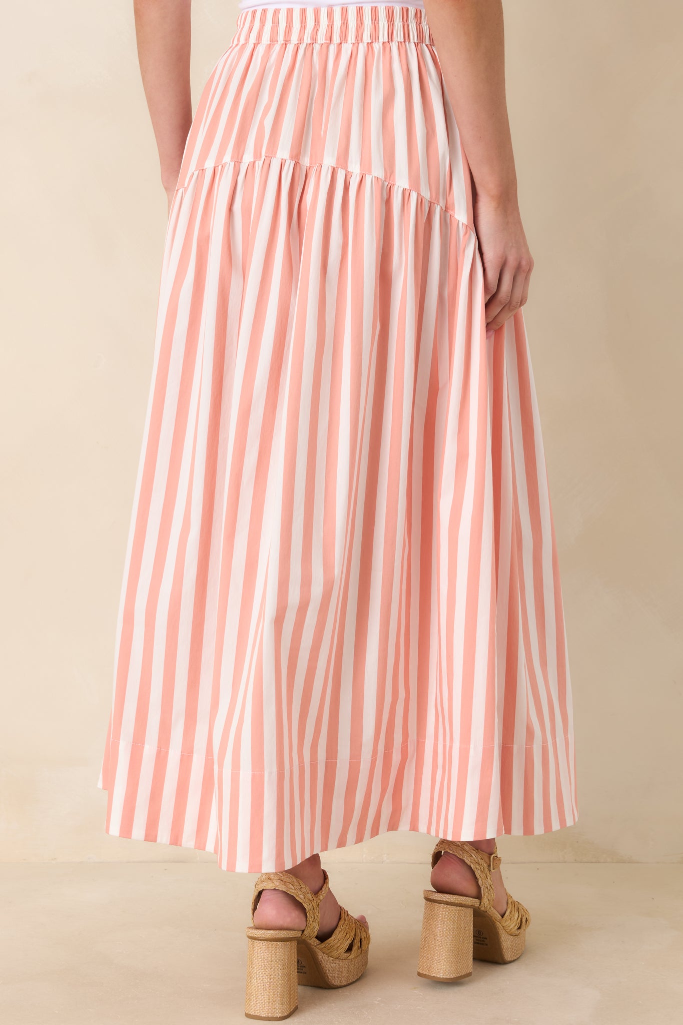 Rear view of the tiered maxi skirt featuring vertical stripe pattern, fitted waist, and flowing full-length silhouette.