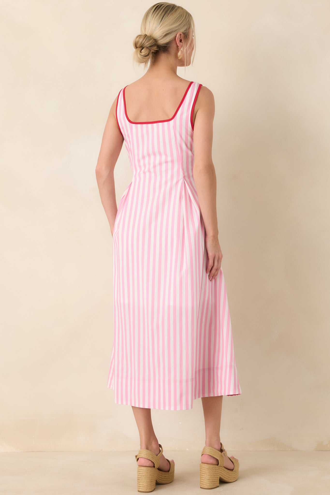Rear view of the striped midi dress featuring a hidden side zipper and flowing skirt.