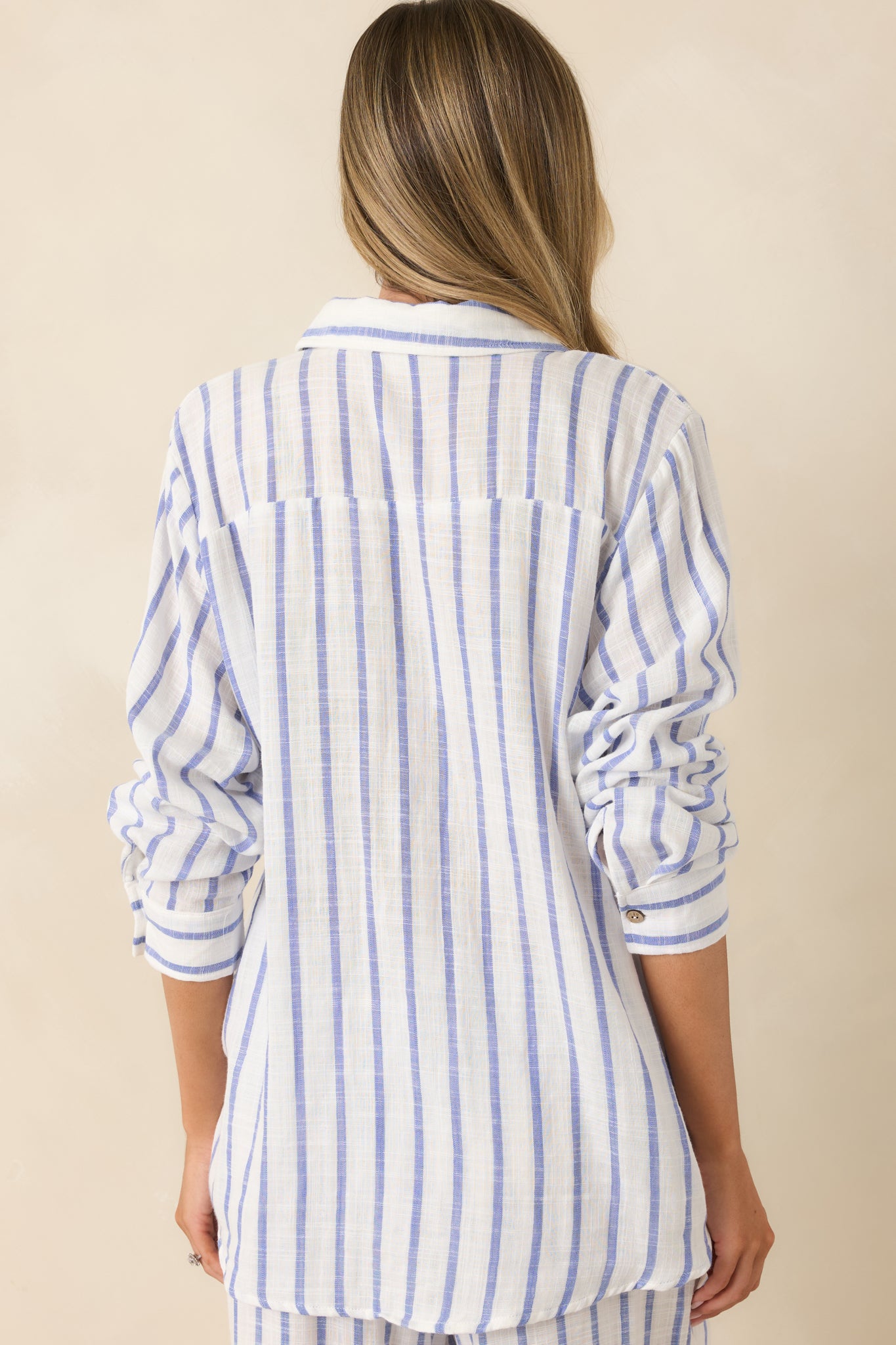 Rear view of the blue striped button-up shirt featuring a relaxed fit and subtle back yoke detailing.