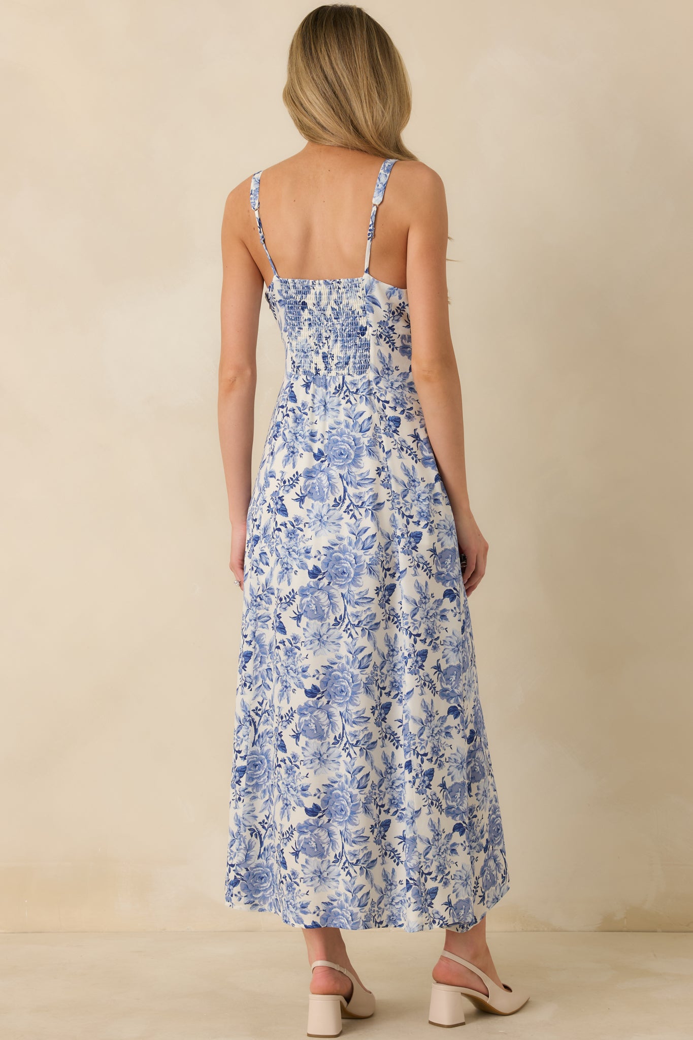 Rear view of blue floral maxi dress featuring a smocked back panel for stretch and flexible shaping.