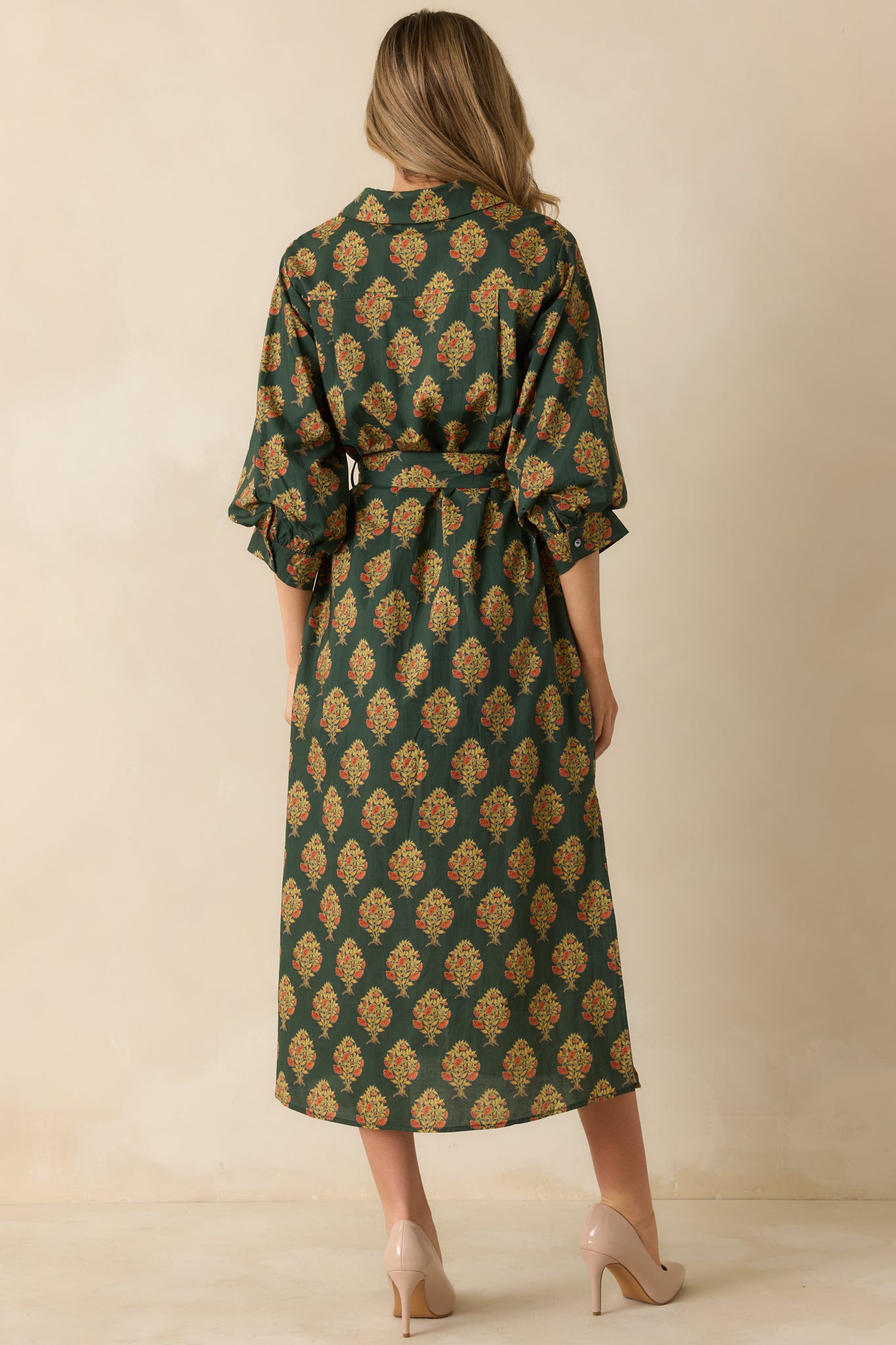 Rear view of the dark green floral maxi dress showing the full length and relaxed fit silhouette.