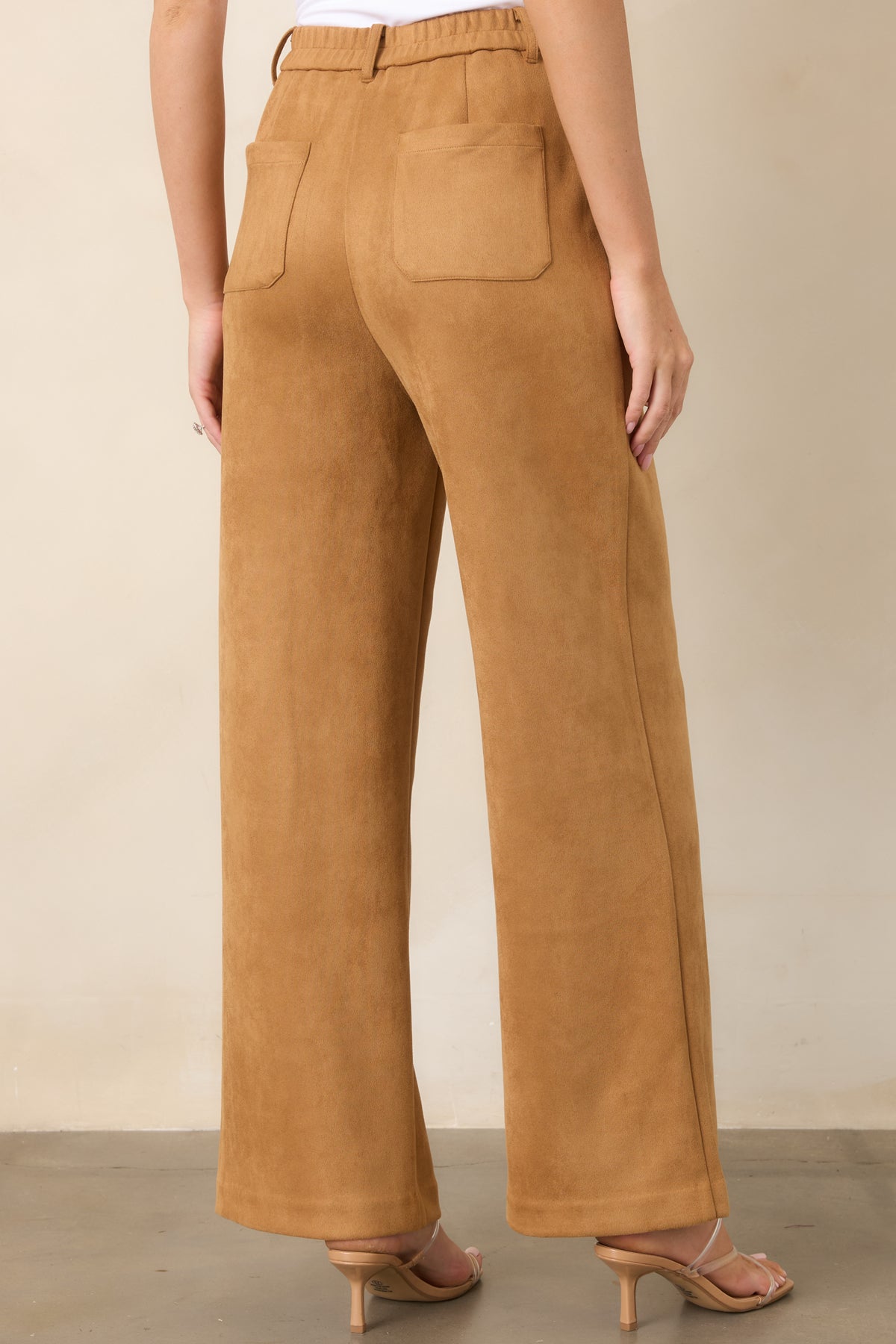 Rear view of the full-length wide-leg pants featuring an elasticized back waistband, belt loops, and practical back patch pockets.