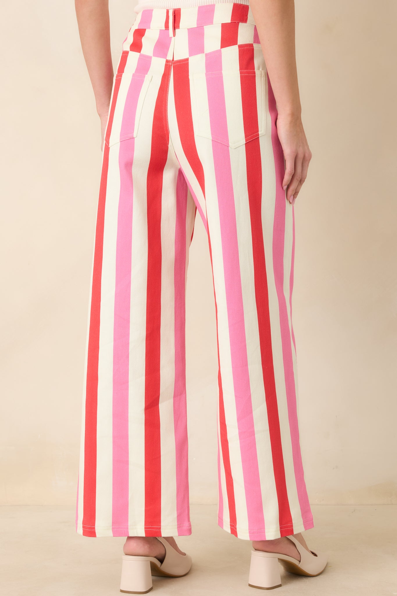 Rear view of high-rise striped pants highlighting wide-leg silhouette and clean back construction.