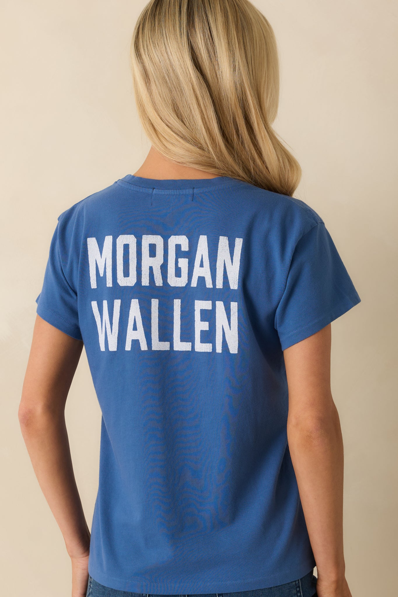 Rear view of the indigo cotton tee showing the bold back graphic lettering and relaxed fit.