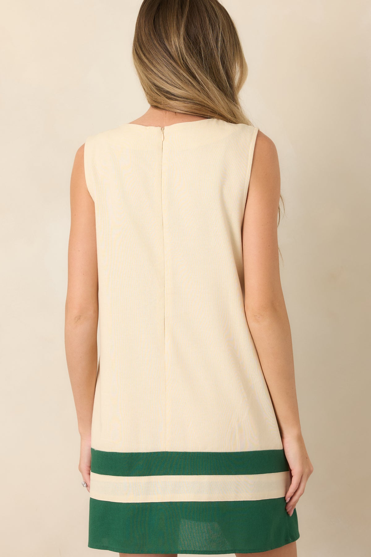 Rear view of the ivory rayon-linen mini dress showing the relaxed shift silhouette, sleeveless design, round neckline, and hidden back zipper.
