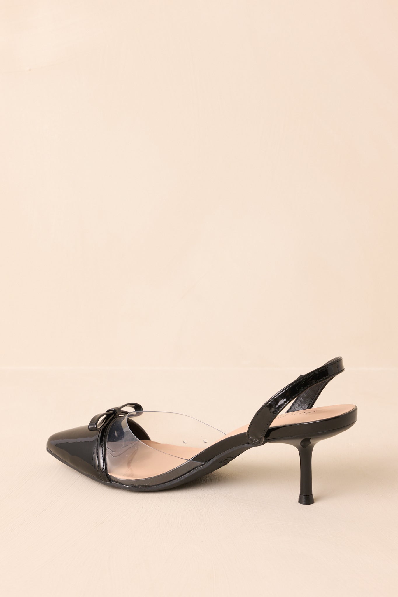 Rear view of the kitten heels, highlighting the slim strap around the rear of the foot and short heel construction.