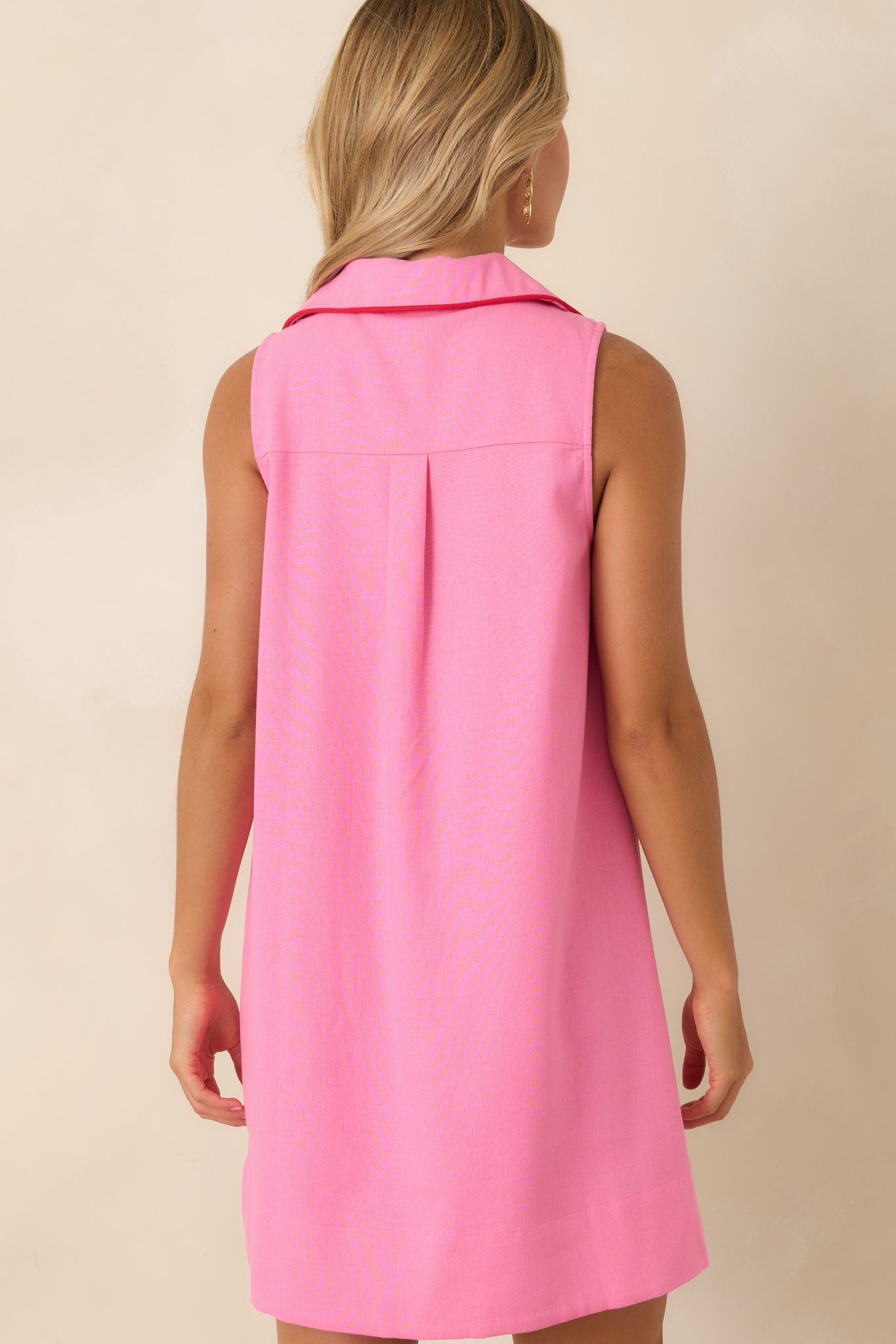 Rear view of the linen blend mini dress featuring a center back pleat, relaxed A-line shape, and smooth flowing fabric.