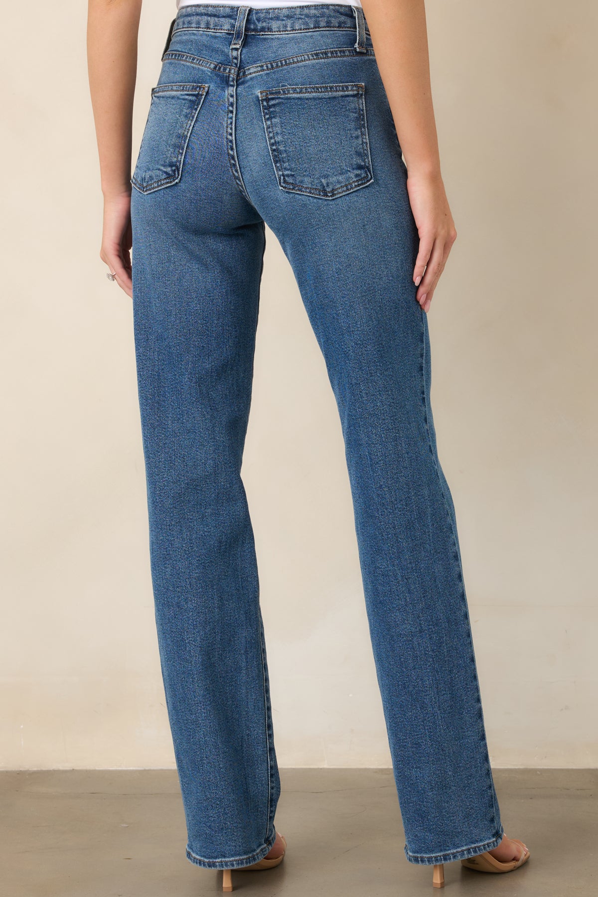 Rear view of the elongated straight-leg pants showcasing their clean silhouette, streamlined fit, and extended inseam.