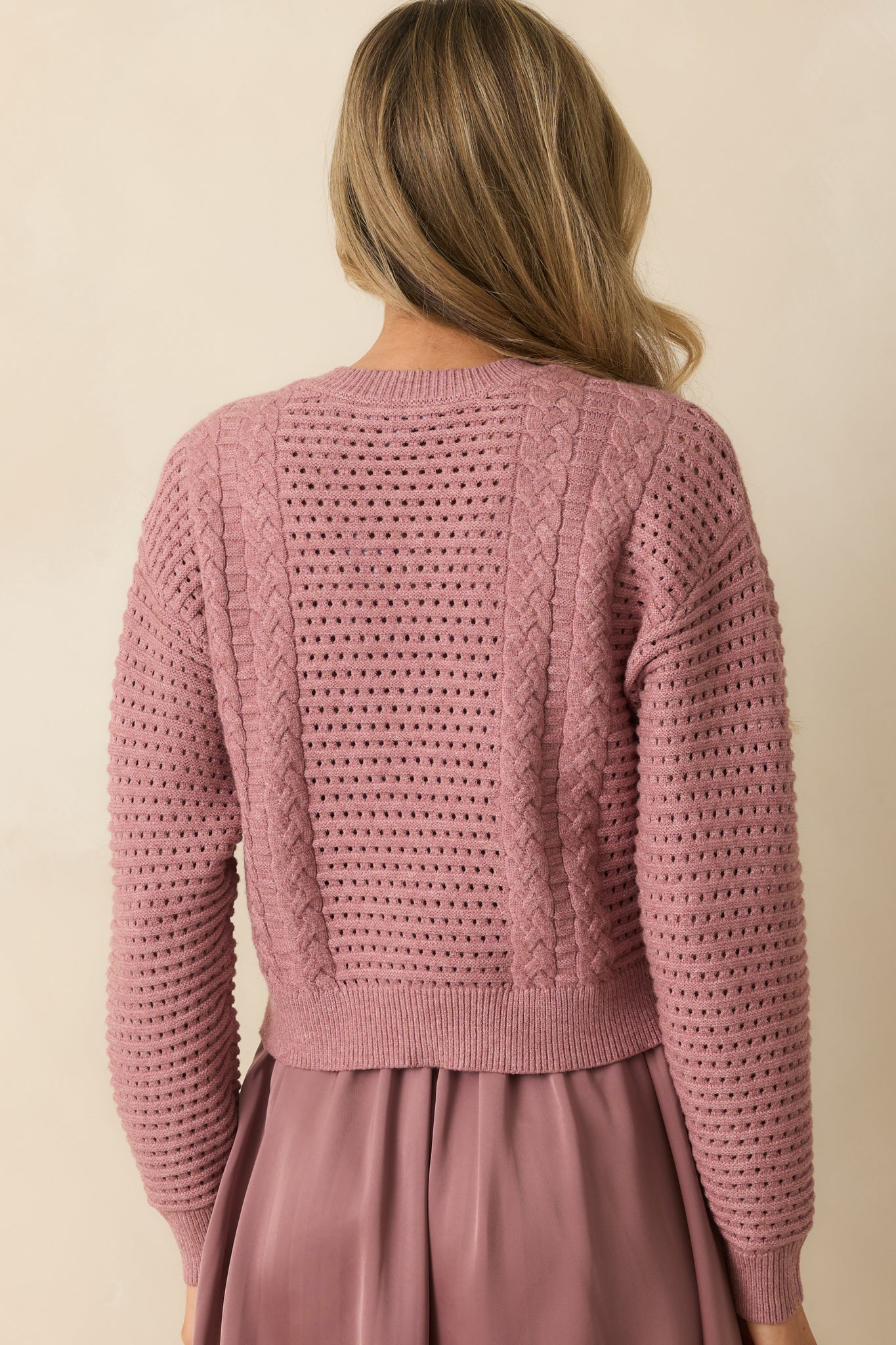 Rear view of the mauve two-piece set highlighting the flowy satin skirt and relaxed drape of the knit sweater.