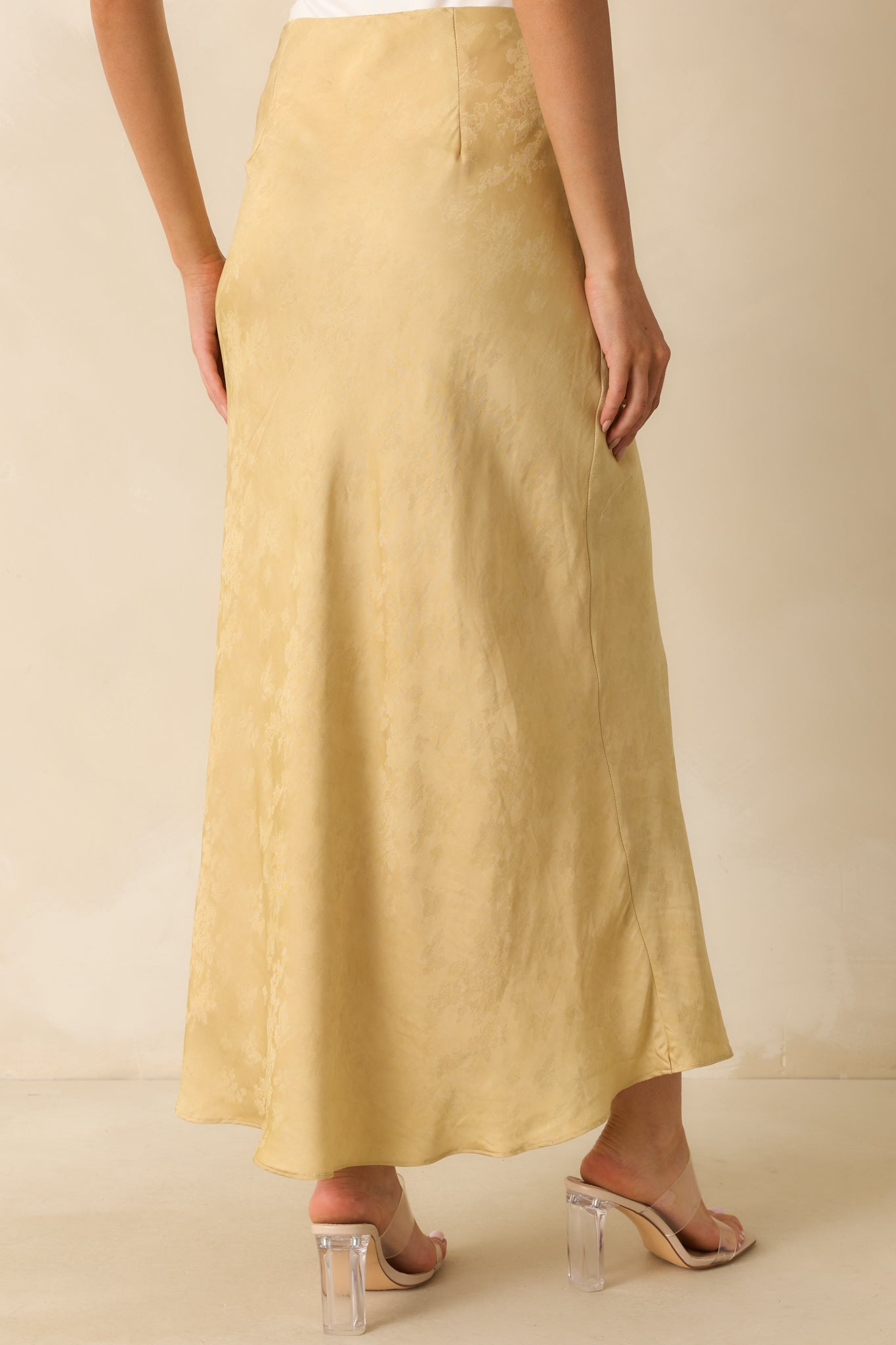 Rear view of the maxi skirt showing the concealed side zipper and full satin drape.