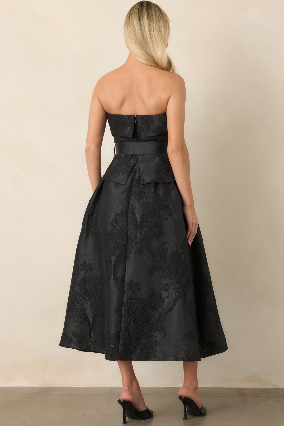 Rear view of the midi dress showing the center back zipper and full pleated A-line skirt.