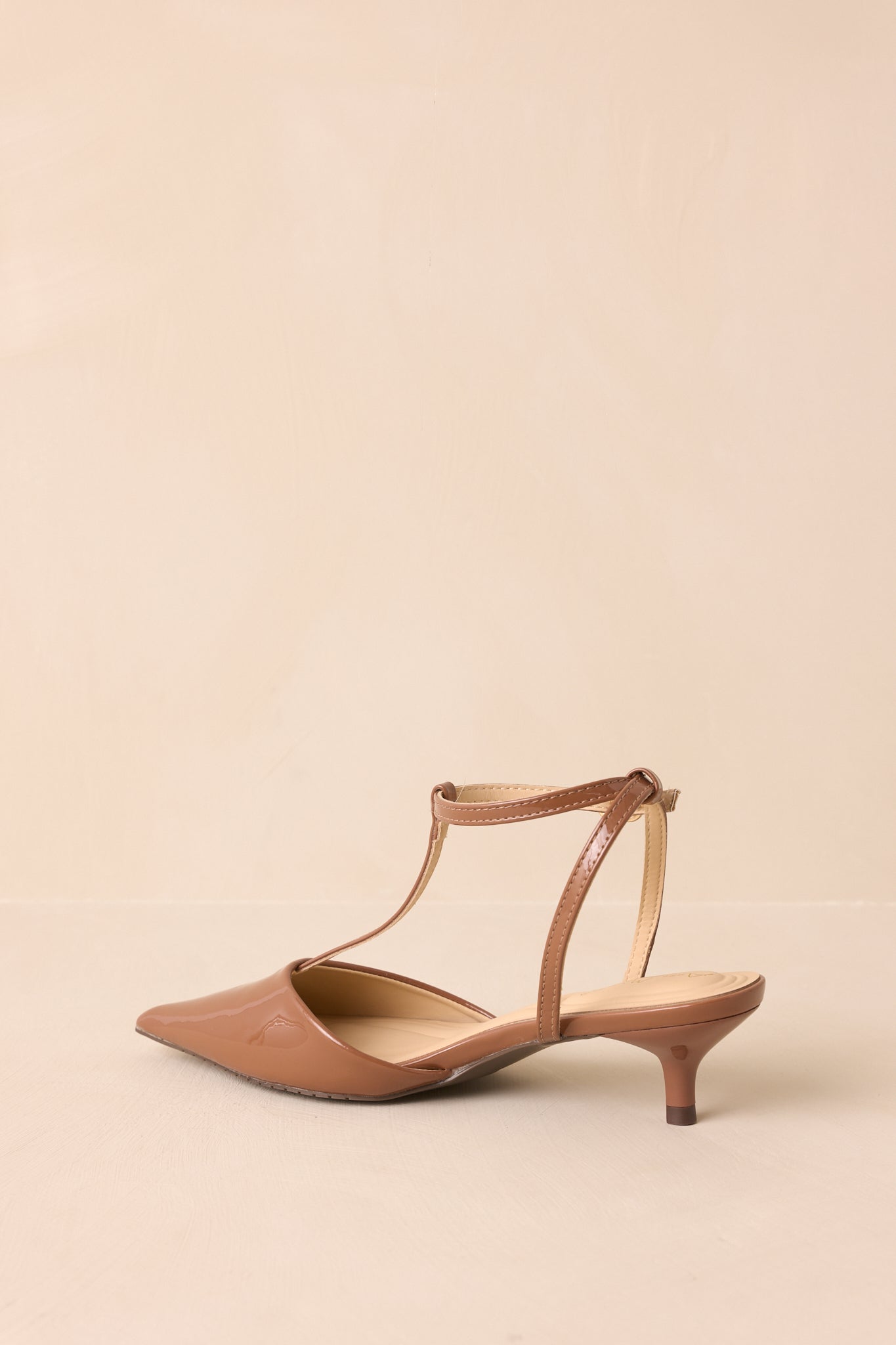 Rear view of the mocha brown heels with a glossy kitten heel and slim ankle strap.