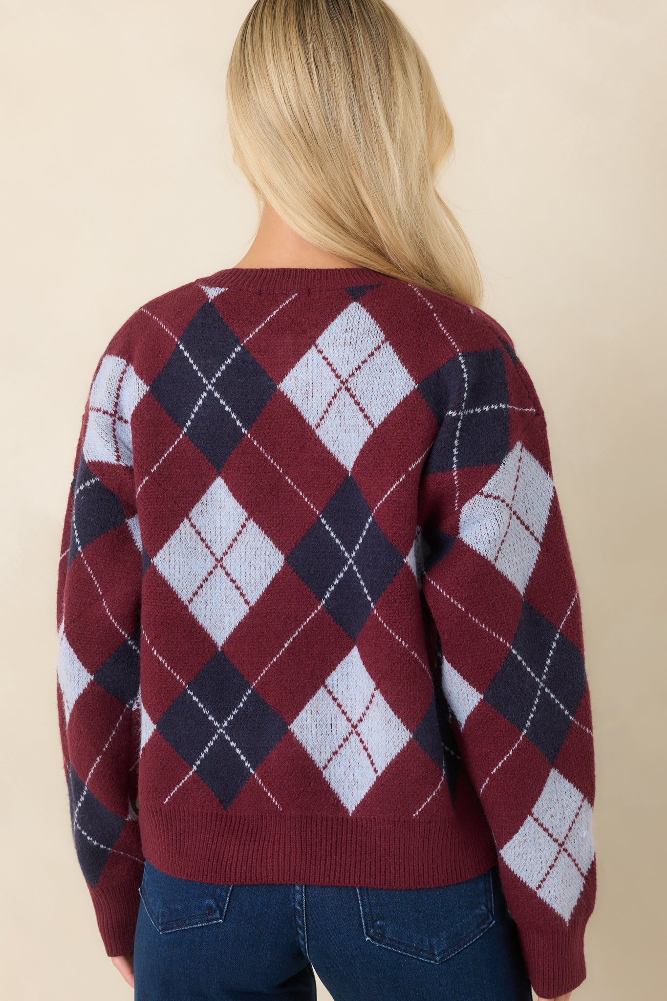Rear view of the burgundy cardigan showcasing the diamond pattern and clean knit construction.