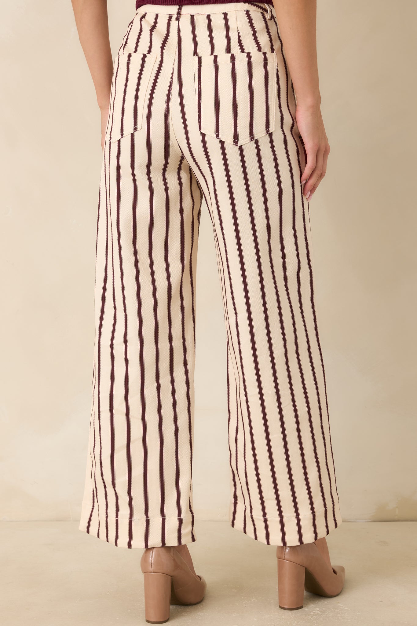 Rear view of the burgundy striped pants highlighting the wide-leg shape, clean back design, and tailored finish.