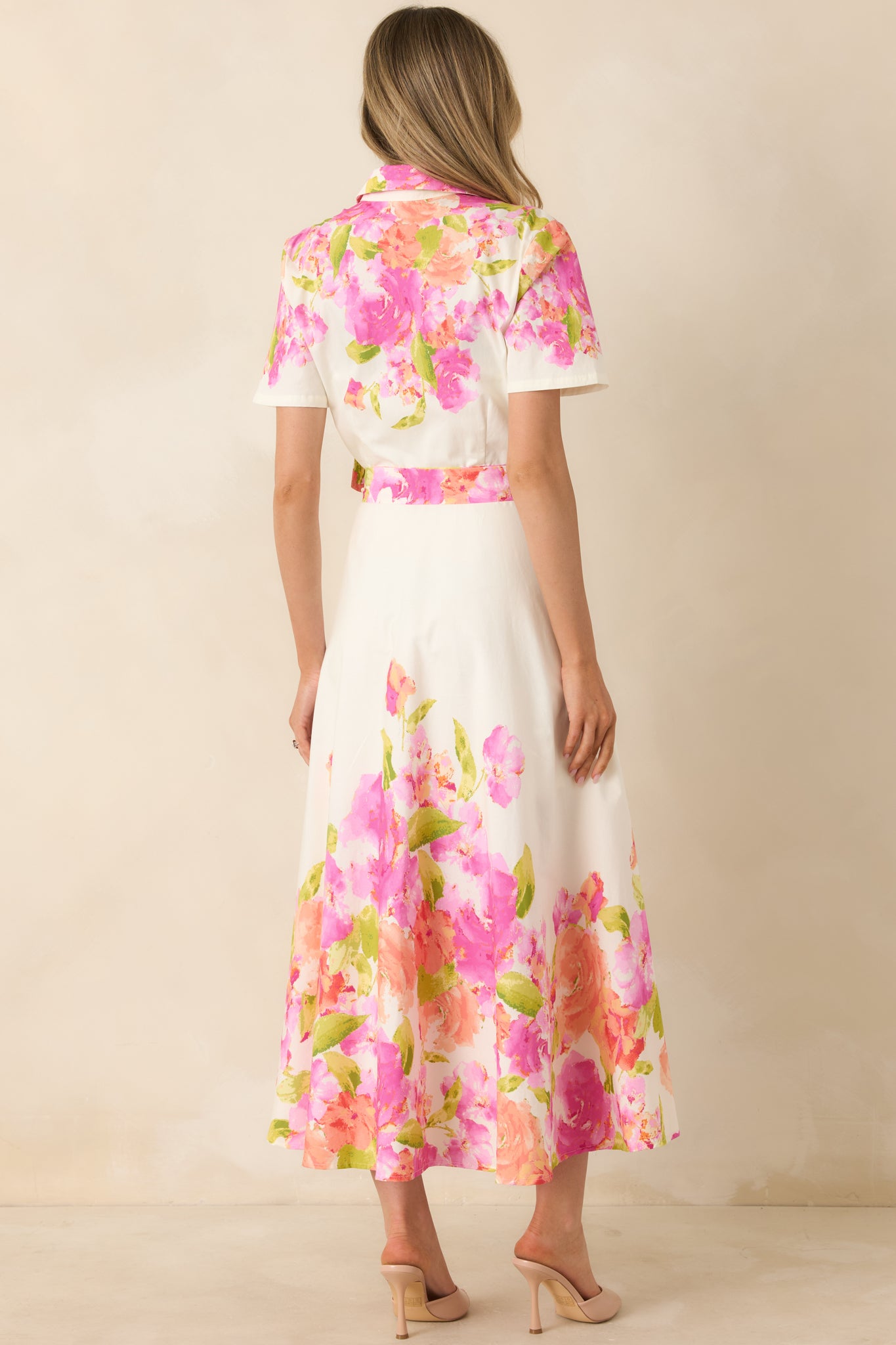 Rear view of cotton dress with full midi-length skirt, short sleeves, and relaxed tailored fit.