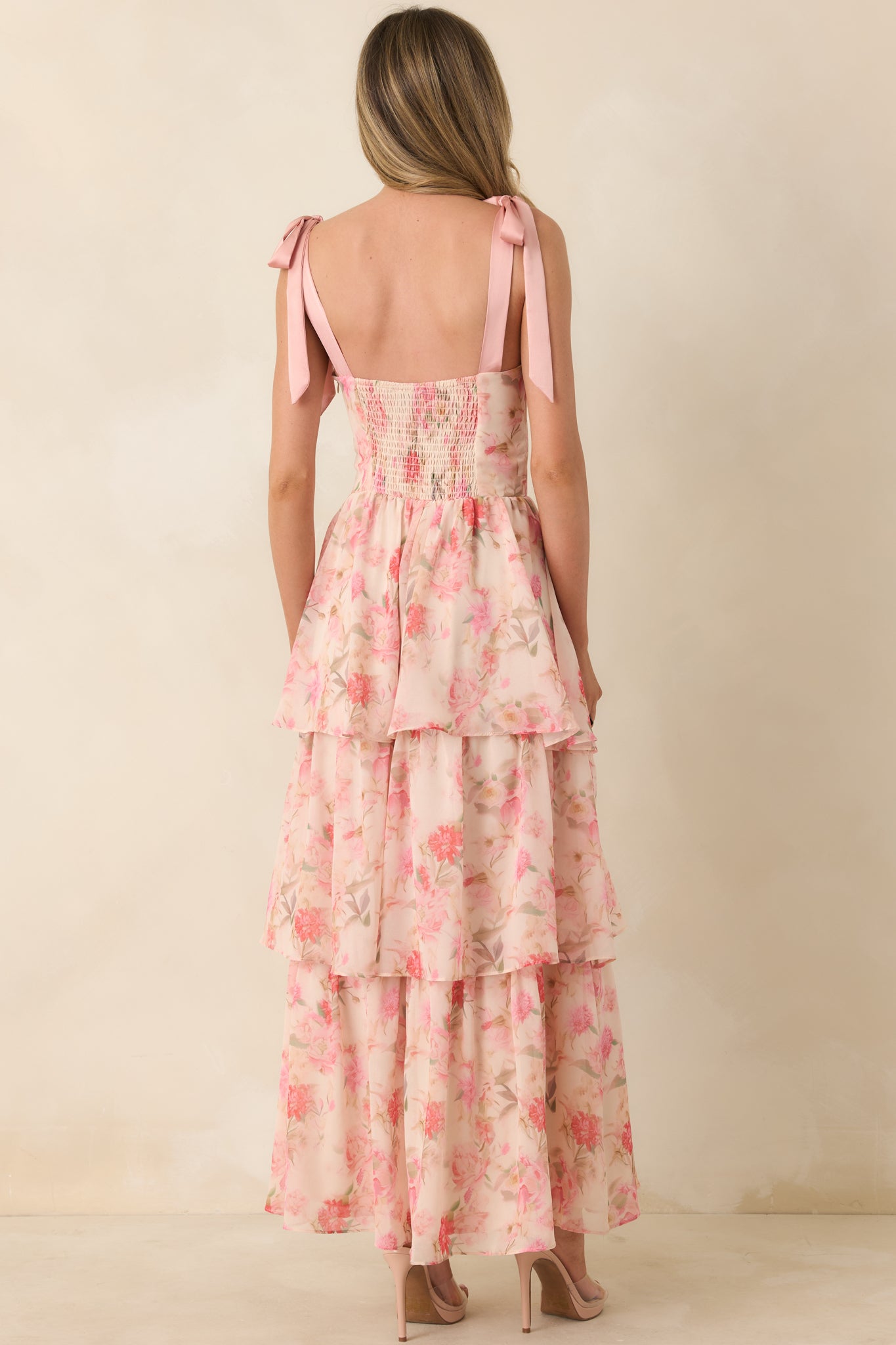 Rear view of chiffon dress with smocked back panel, tiered skirt, and adjustable tie shoulder straps.