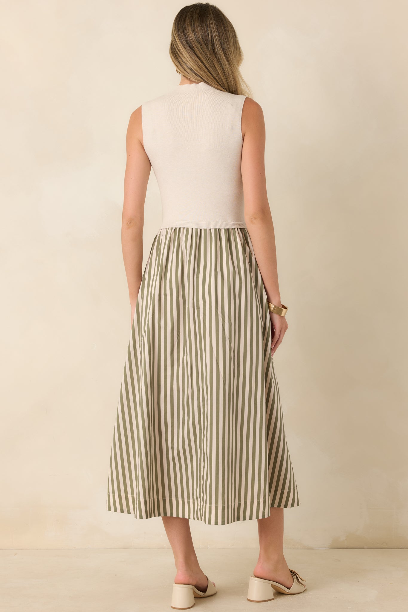 Rear view of the ecru midi dress showcasing the sleeveless construction and flowing A-line skirt with sage green stripes.