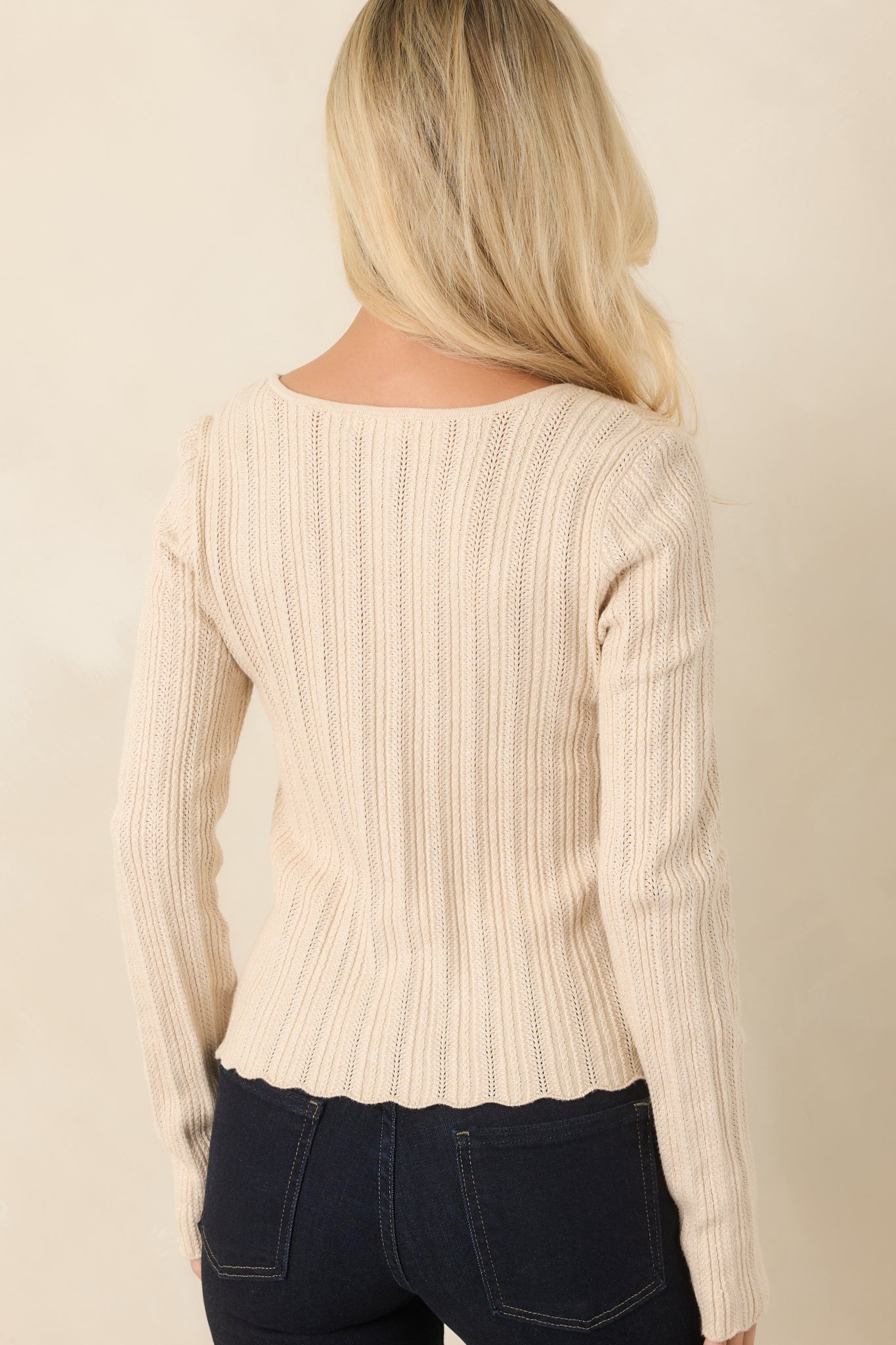 Rear view of the fitted knit top showcasing the clean silhouette and soft textured fabric.