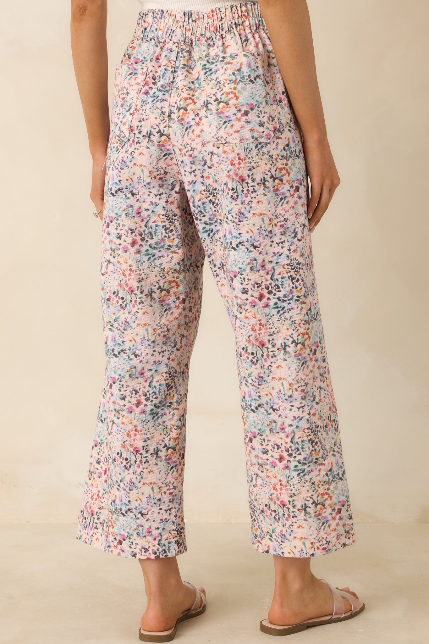 Rear view of floral pants showing elasticized waistband and back patch pocket.