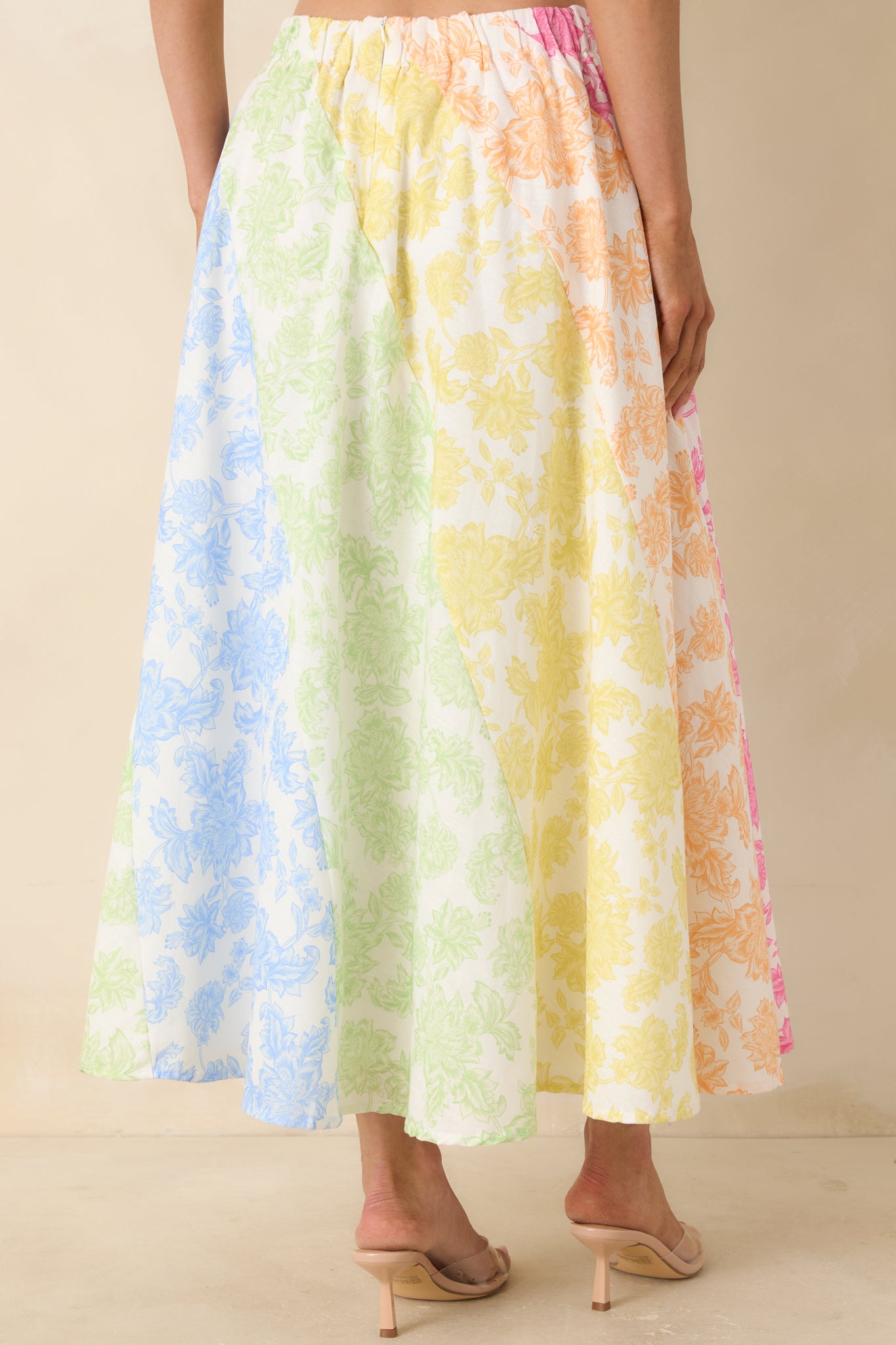 Rear view of full midi skirt with high-rise fit, flowing silhouette, and vibrant floral color-block print.