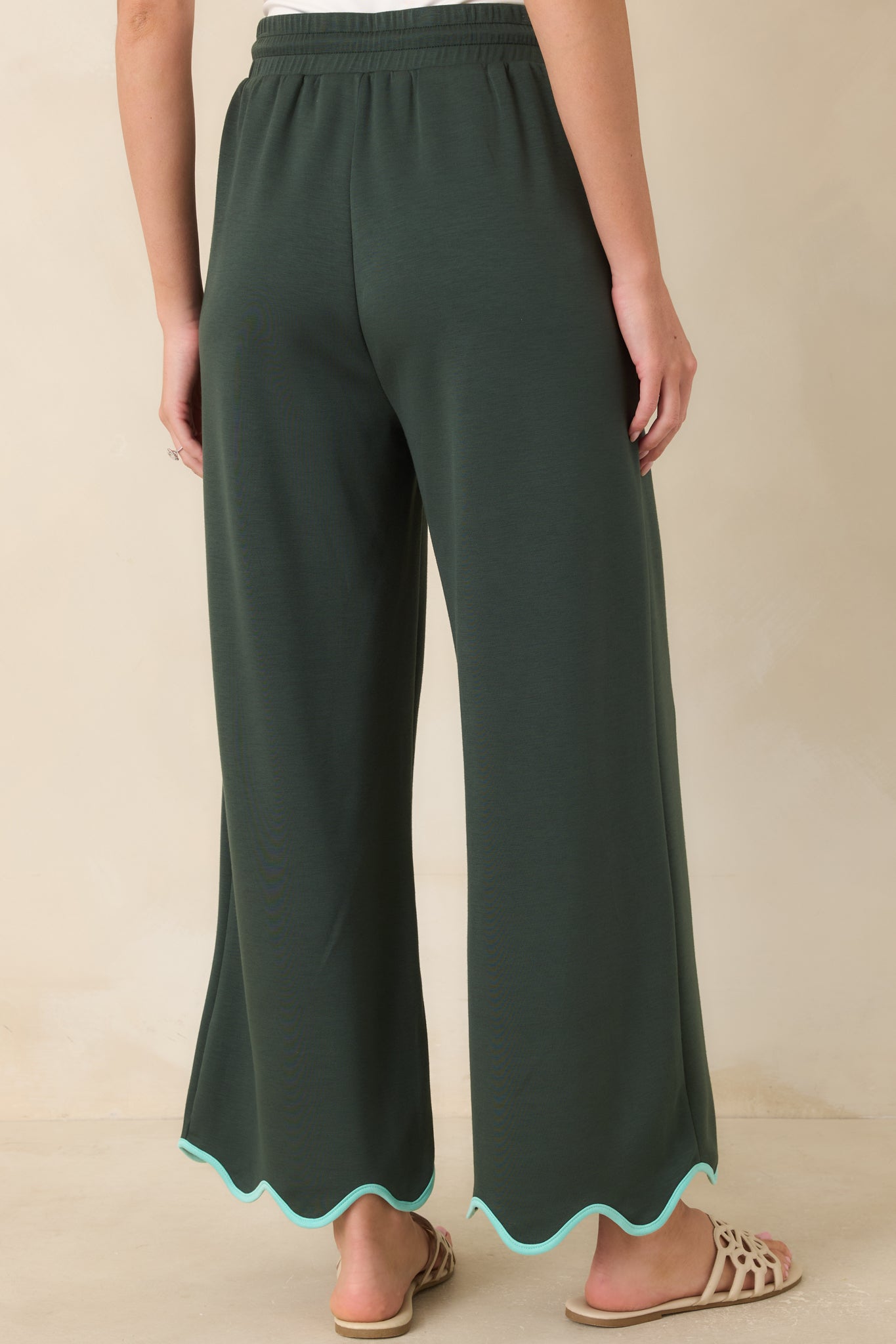 Rear view of the hunter green knit pants showcasing the relaxed wide leg silhouette and smooth back design.