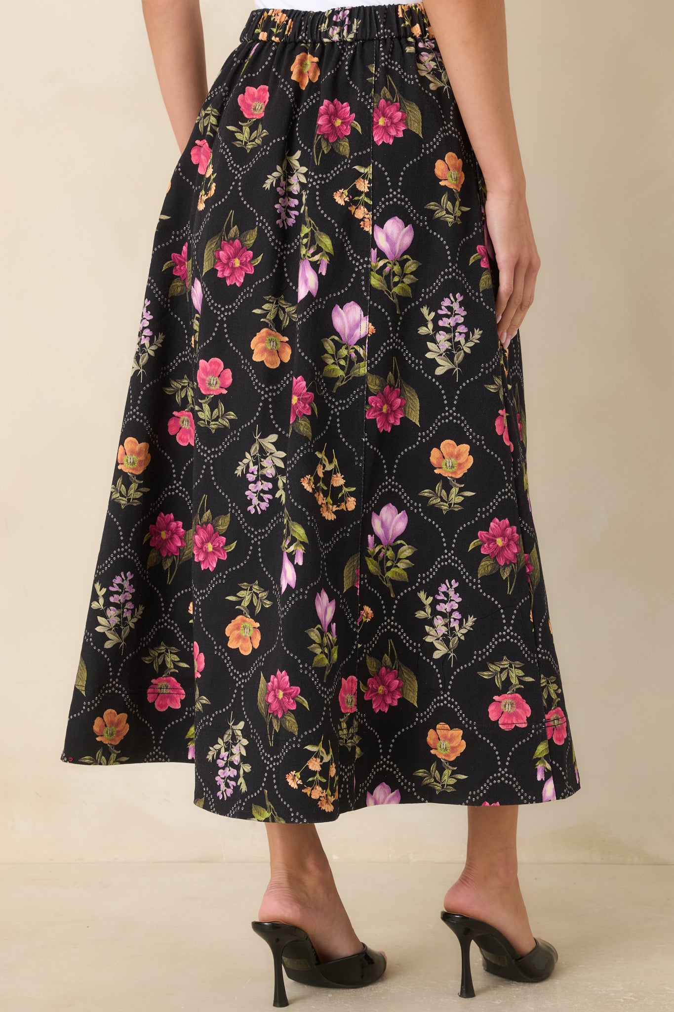 Rear view of the maxi skirt showcasing the elasticized waistband and flowing A-line silhouette.