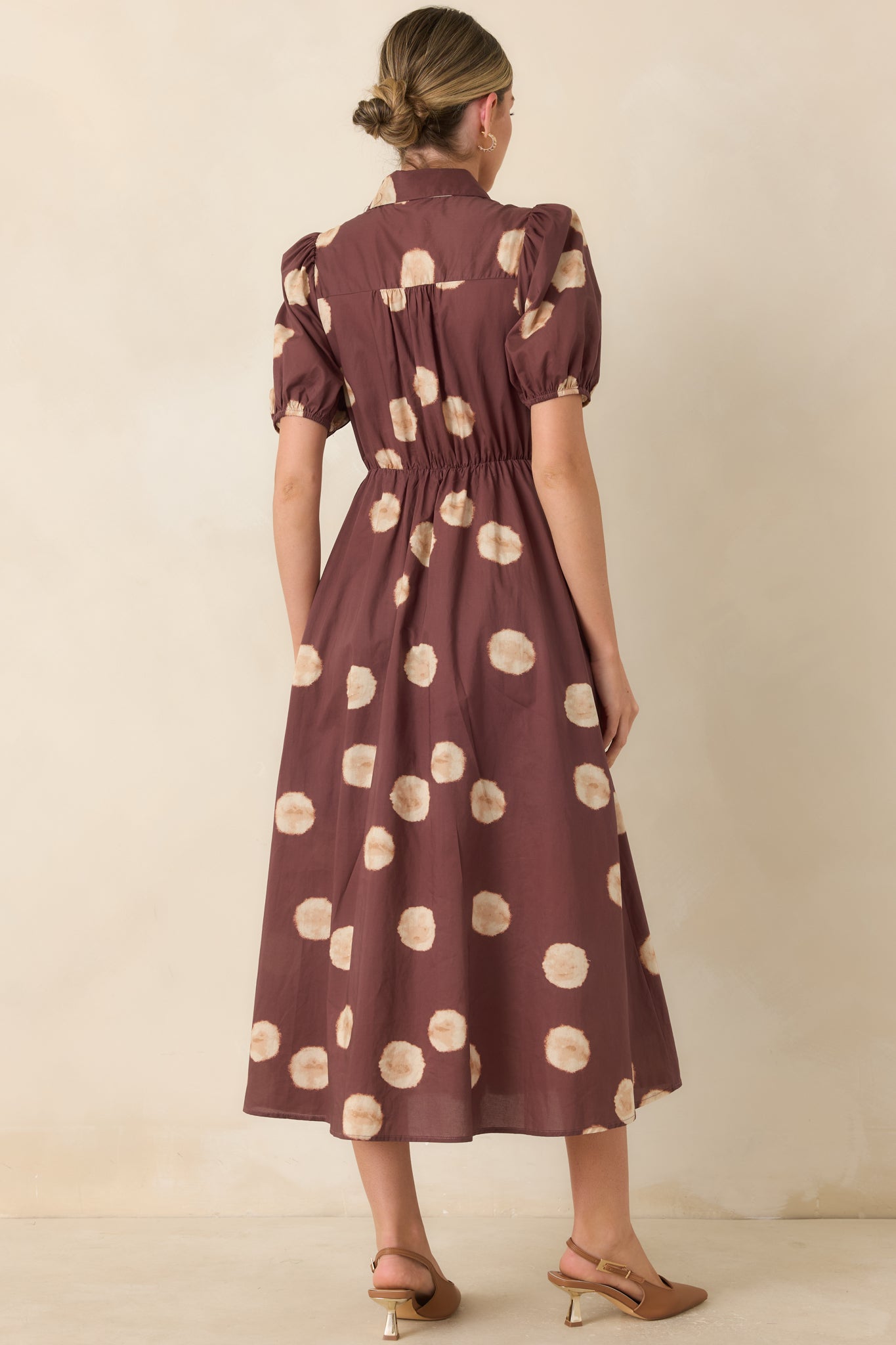 Rear view of the midi dress highlighting the elastic back waistband and the graceful movement of the A-line skirt.