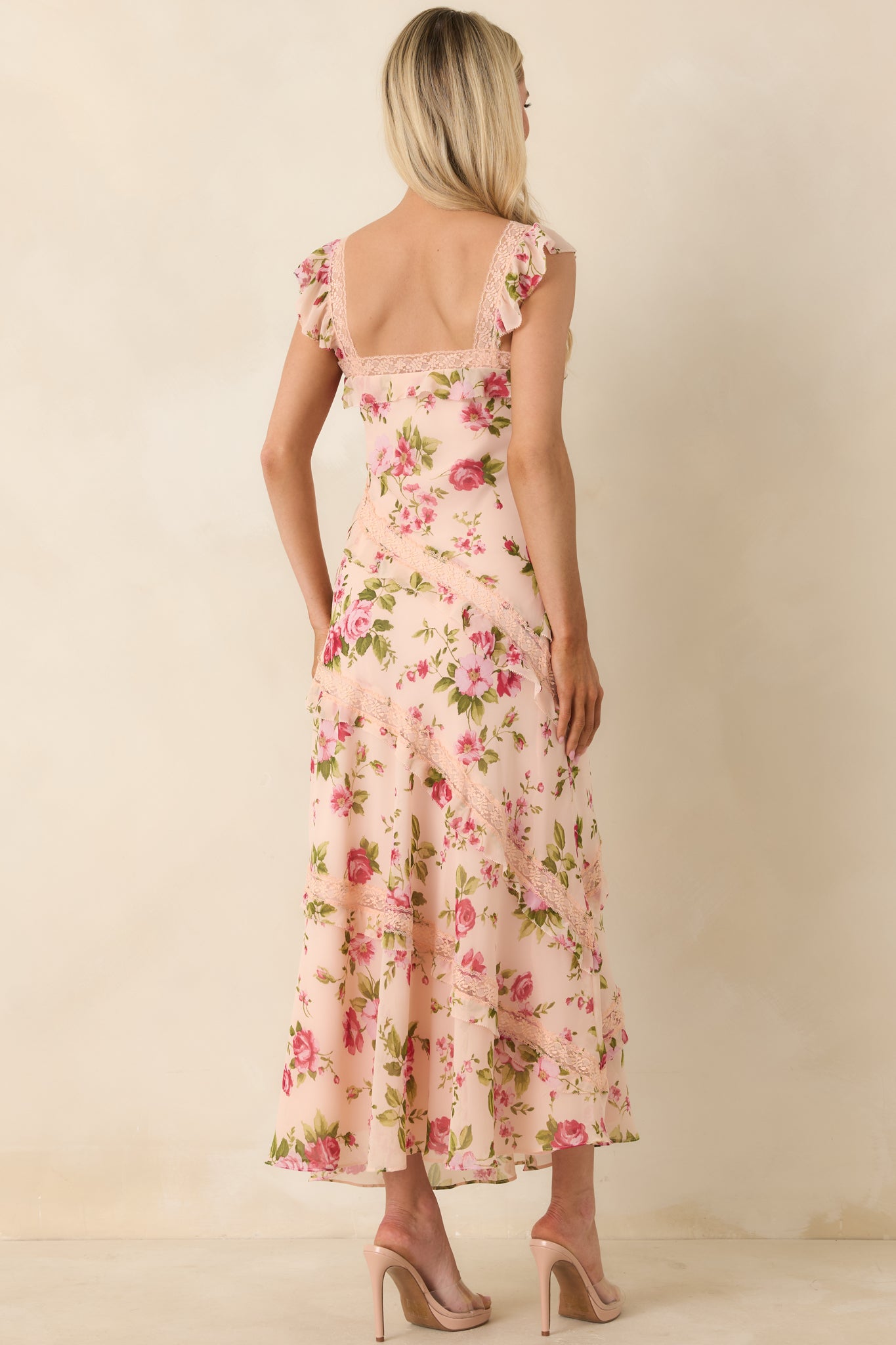 Rear view of midi dress with flutter straps, lace accents, and flowing layered ruffle silhouette.