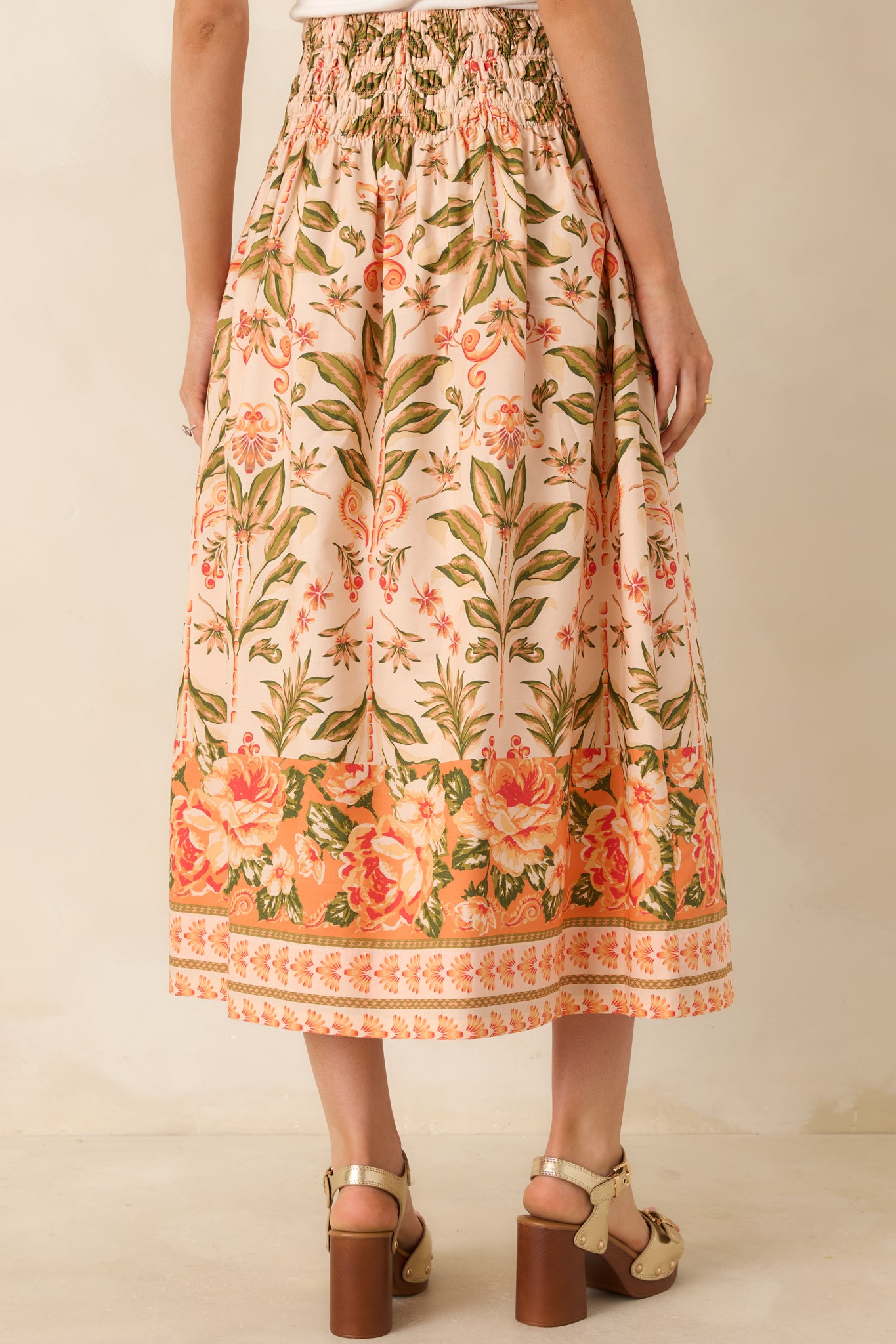 Rear view of midi skirt with smocked waistband and relaxed fit.