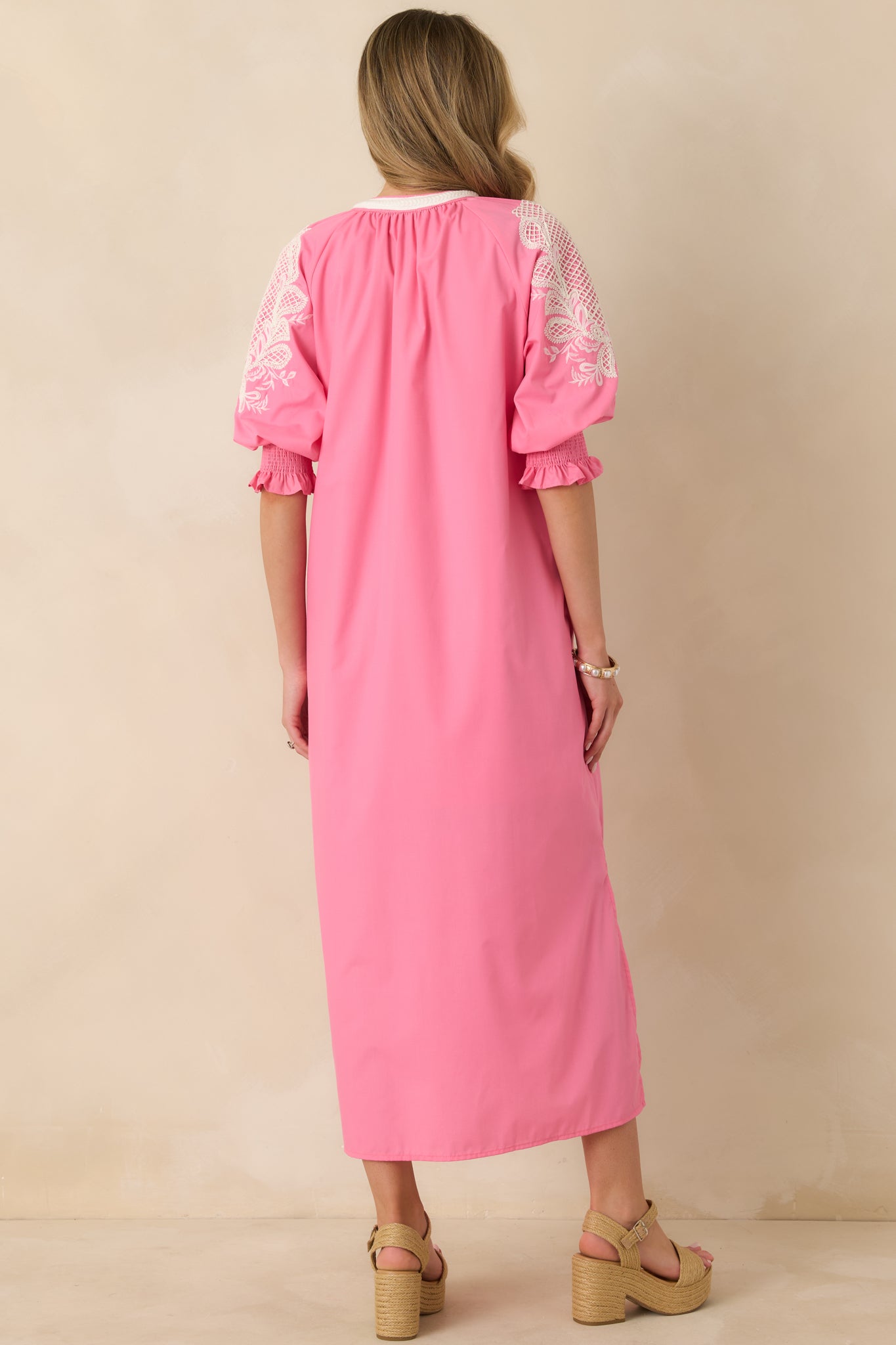 Rear view of pink maxi dress showing flowing maxi-length skirt and relaxed silhouette.