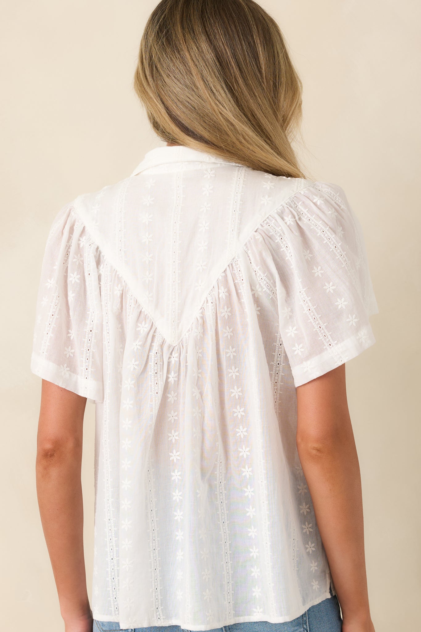 Rear view of relaxed cotton top with airy drape and lightweight feel.

