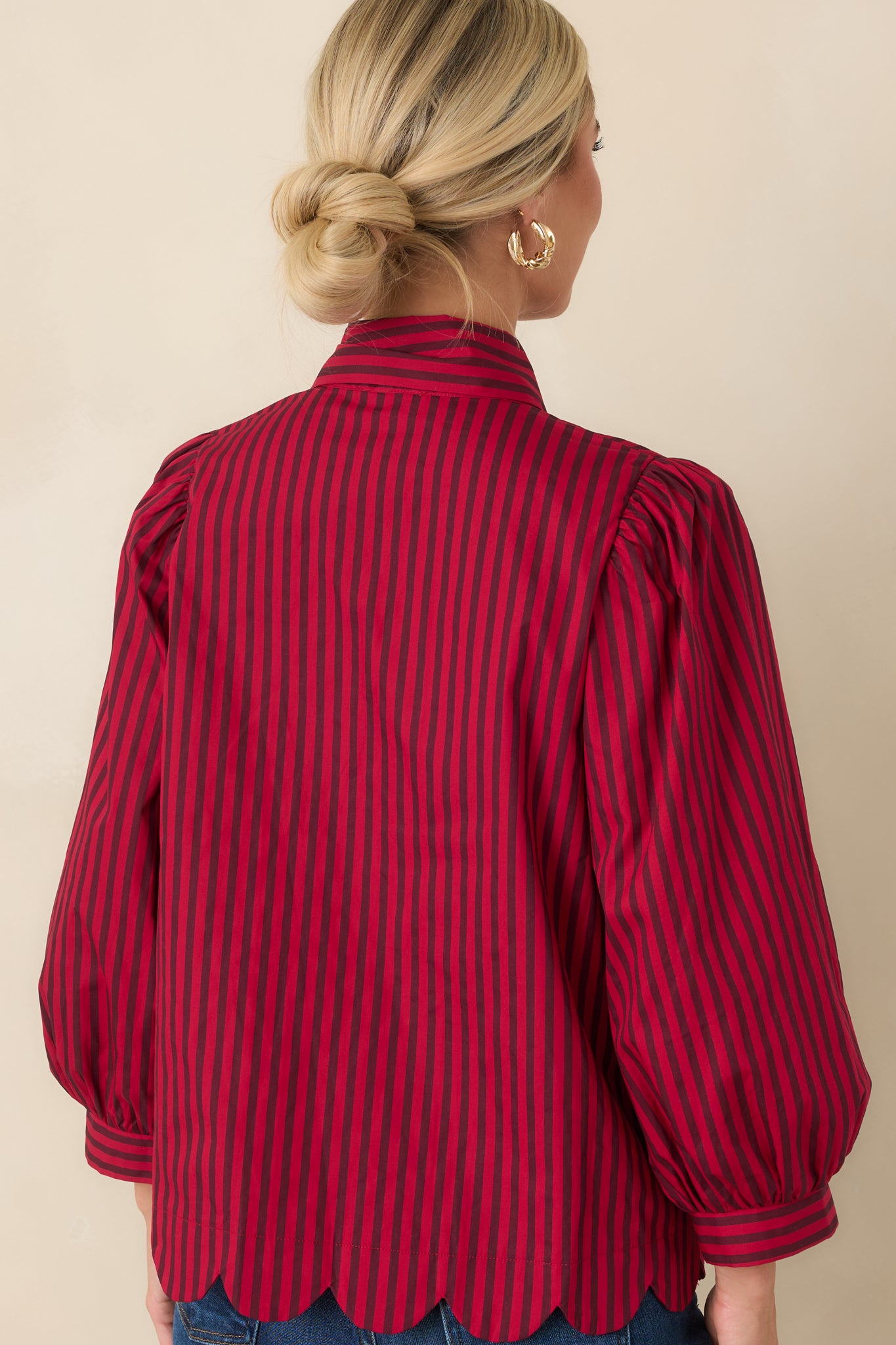 Rear view of the striped cotton blouse highlighting the relaxed silhouette, gathered shoulders, and flowing back design.