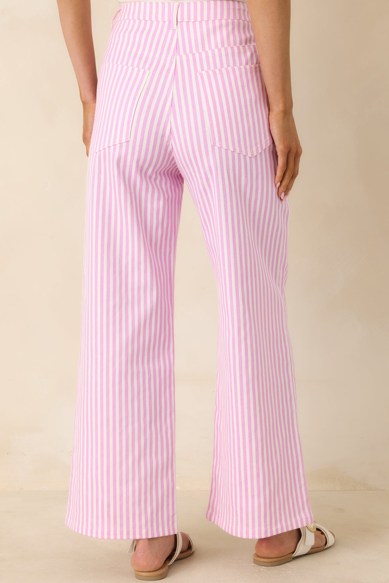 Rear view of striped cotton pants with structured fit and vertical pattern.