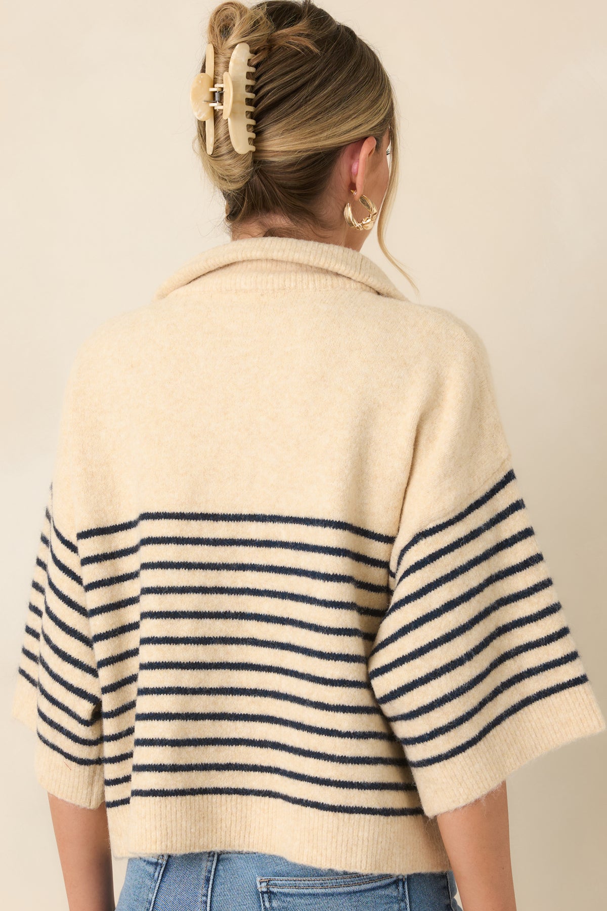 Rear view of the striped knit top showcasing the oversized silhouette and slightly cropped hem.