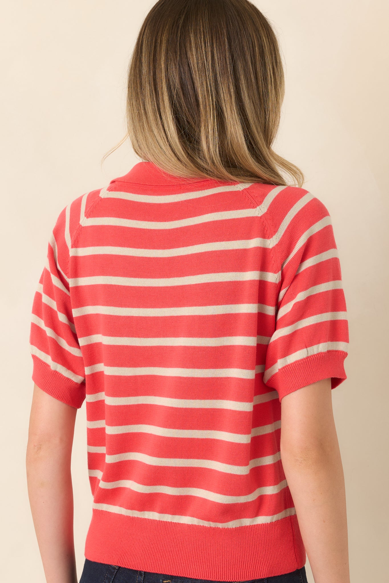 Rear view of the striped knit top showcasing the relaxed silhouette and ribbed hem detailing.